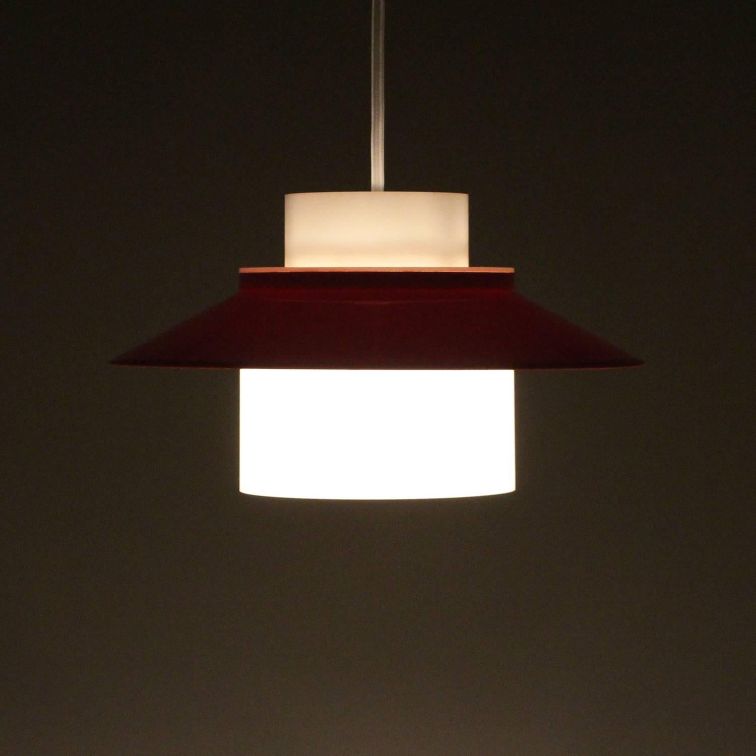 Dinette by Bent Karlby, 1970, produced by Lyfa - Scandinavian Modern red and white acrylic plastic ceiling light in excellent vintage condition.

This stylish pendant is made up of two parts of cast acrylic plastic. The inner core is translucent