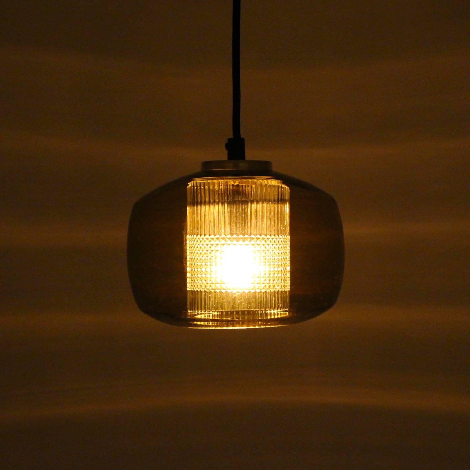 Amber crystal glass pendant light by unknown Scandinavian producer in the 1960s - vintage crystal glass ceiling light with brass top in very good, near excellent vintage condition.

This charming beauty is comprises by a light amber, almost
