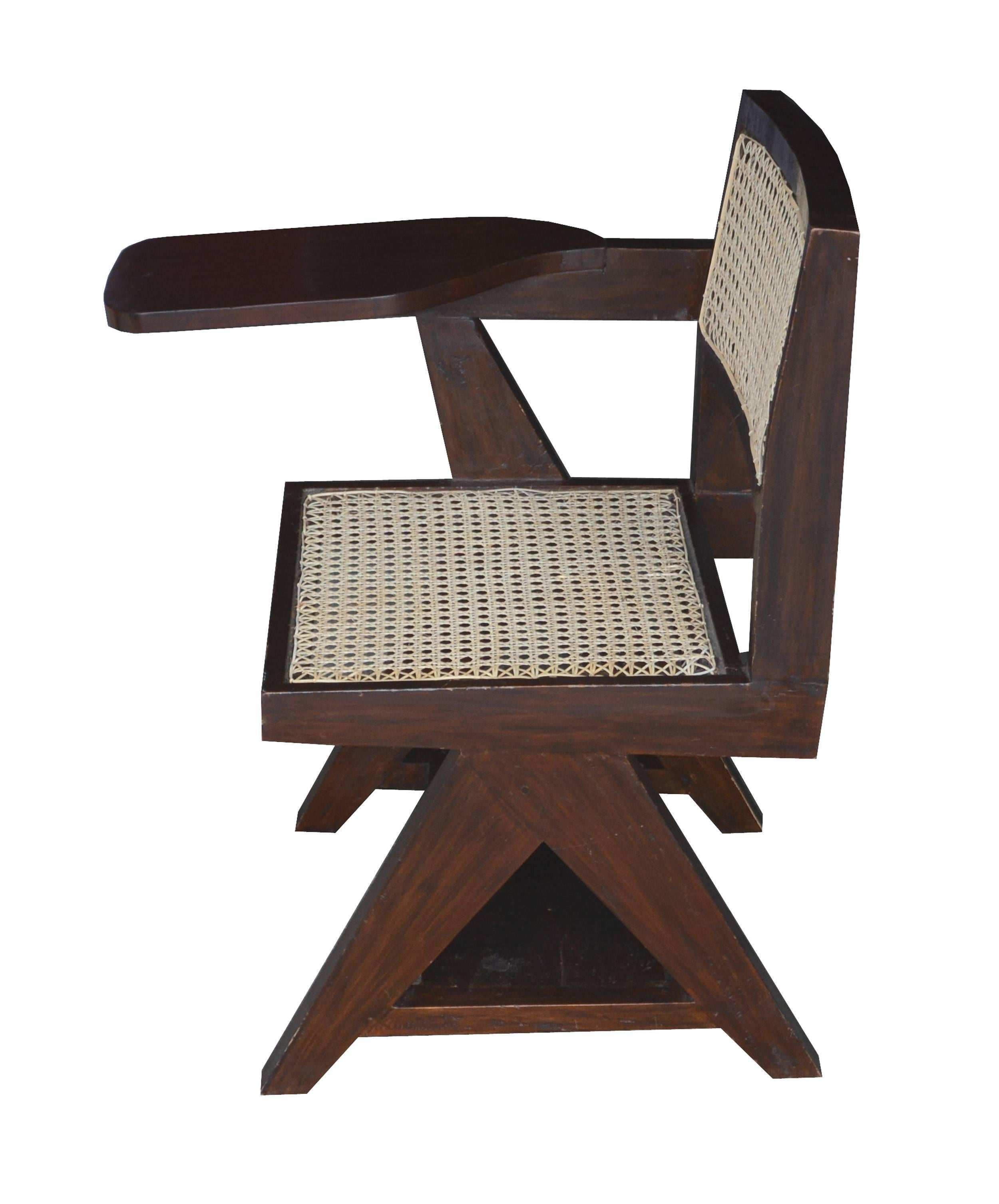 Pierre Jeanneret, teakwood writing cane chair from Punjab University in Chandigarh, India. See photo before restoration when I bought it in Chandigarh in 1999.
Version with inverted Y leg and tablet under seat. New cane (all these chairs coming