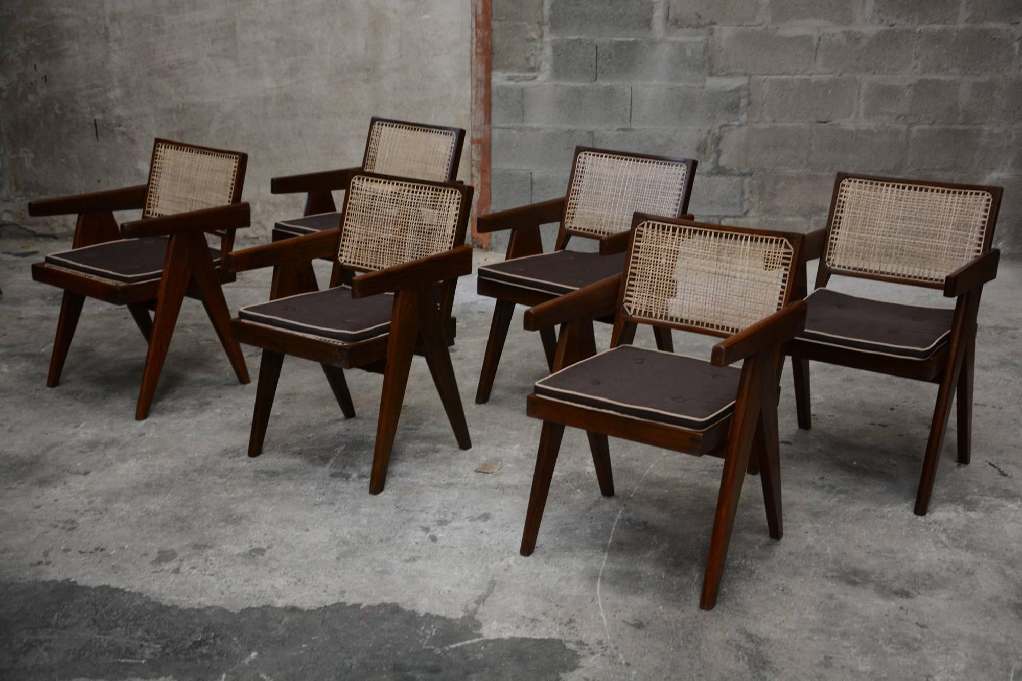 Pierre Jeanneret, set of six cane and teak wood office armchairs from administrative buildings in Chandigarh, India. Back attached to the seat. Teak, woven cane and upholstered seat cushion featuring cloth covering. See photo before restoration when