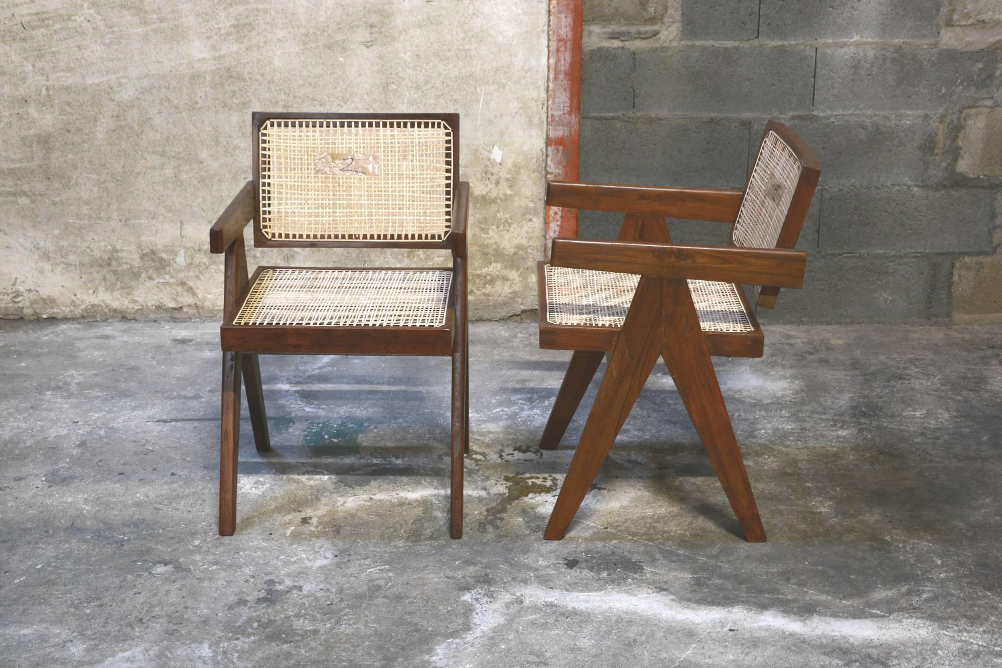 Pierre Jeanneret, set of two cane and teakwood office armchairs from administrative buildings in Chandigarh, India. Version with back separated from the seat. Teak, woven cane and upholstered seat cushion featuring cloth covering. Photo before