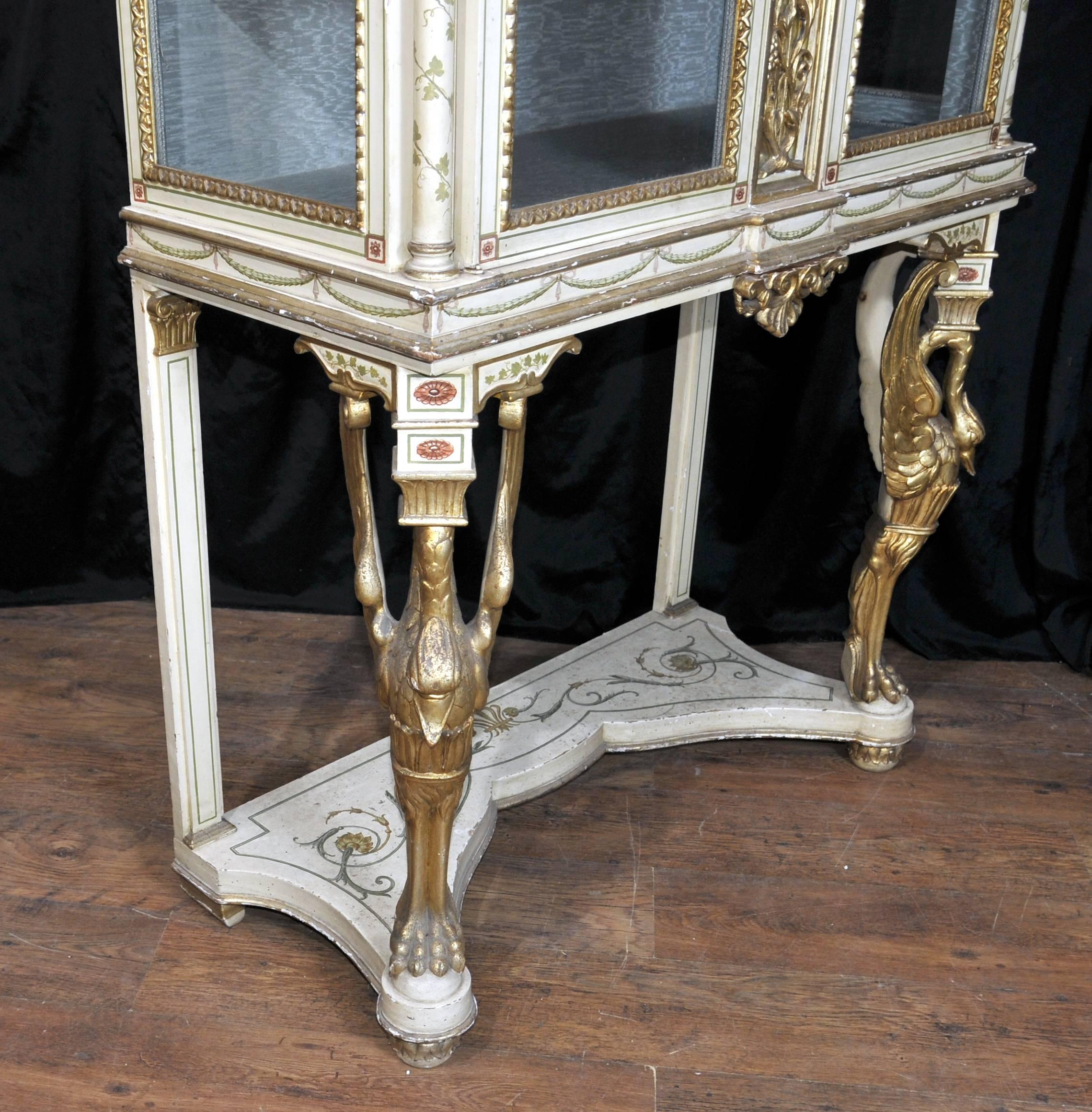 Available to view in the Canonbury Antiques Hertfordshire showroom, just 25 minutes north of London. 
Gorgeous French Empire style antique display cabinet.
Visually arresting piece with painted details offset by gilt features, including