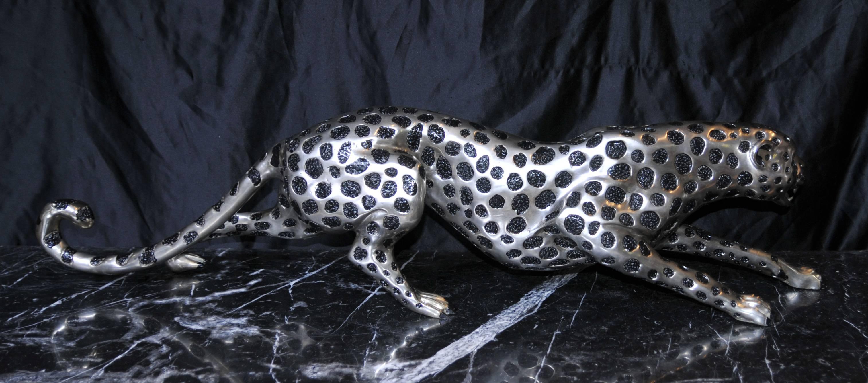 Large silver bronze art deco style casting of a cheetah.
Piece is almost four feet long so large.
Really elegant piece, long and feline, sloping across the floor.
Every designers dream and a great collectors piece.
Fantastic patina to
