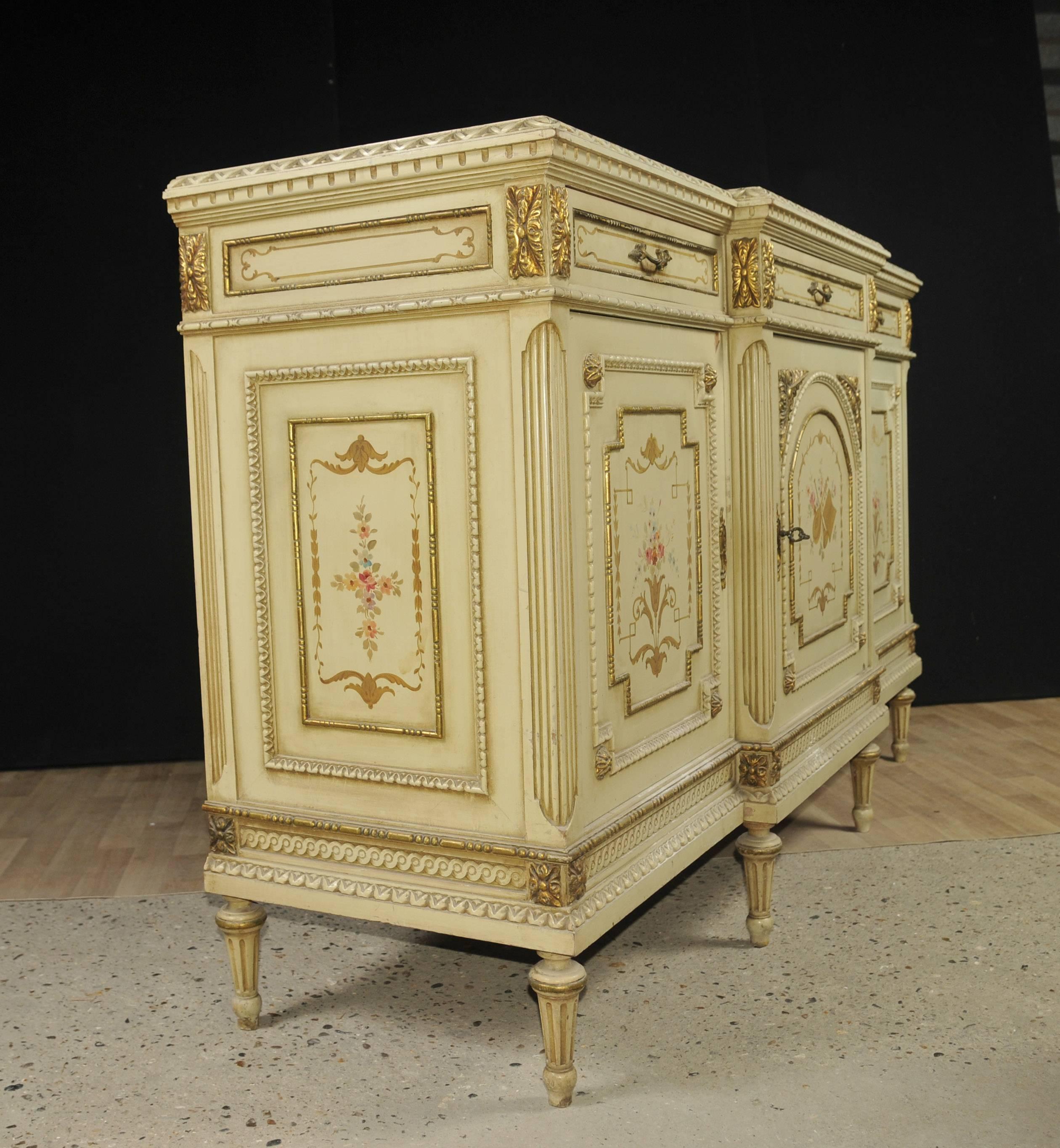 Gorgeous French neoclassical sideboard or cabinet.
Great look to this with painted finish in off-white cream.
This in turn has been pained on and the hand-painted details are very intricate including musical.

Instruments, classical garlands and