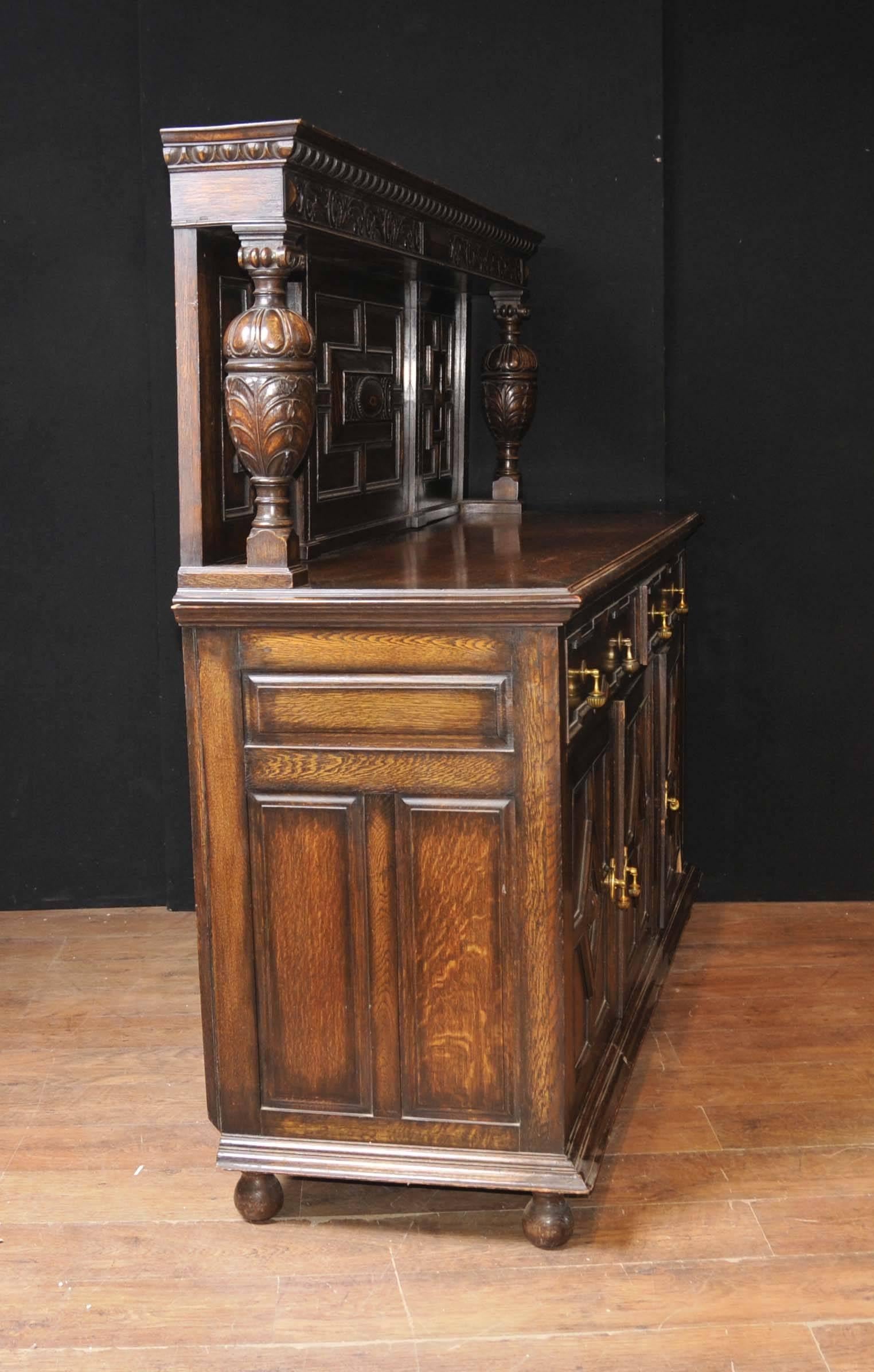 Antique oak Jacobean style sideboard or buffet server.
Hand-carved details are exquisite and this is perfect for that farmhouse look.
Love the hand-carved frieze and bulbous urn supports, really makes this stand out
We have lots of matching oak