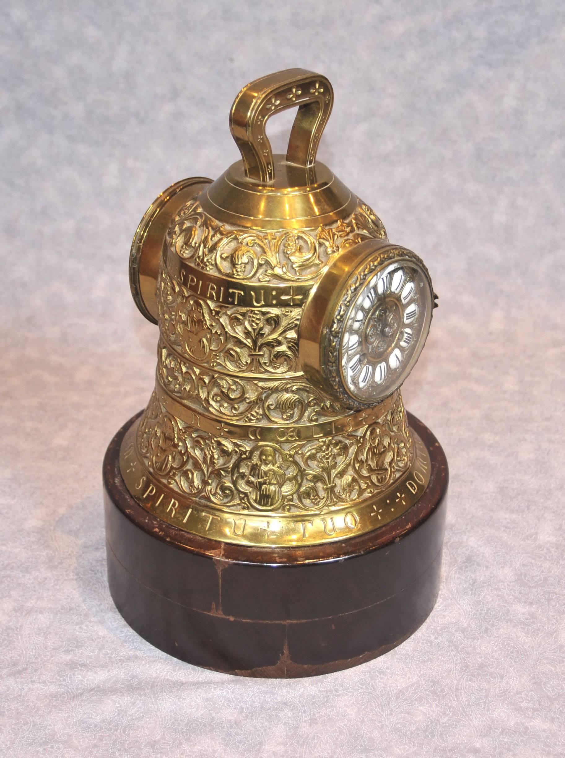 - Quirky and rare antique French clock in the shape of a bell.
- All working and it chimes.
- Metal is incredibly well cast and detailed with all the motifs in relief and inscriptions.
- Piece bares the inscription 'Spiritu tuo dominus vobisaum