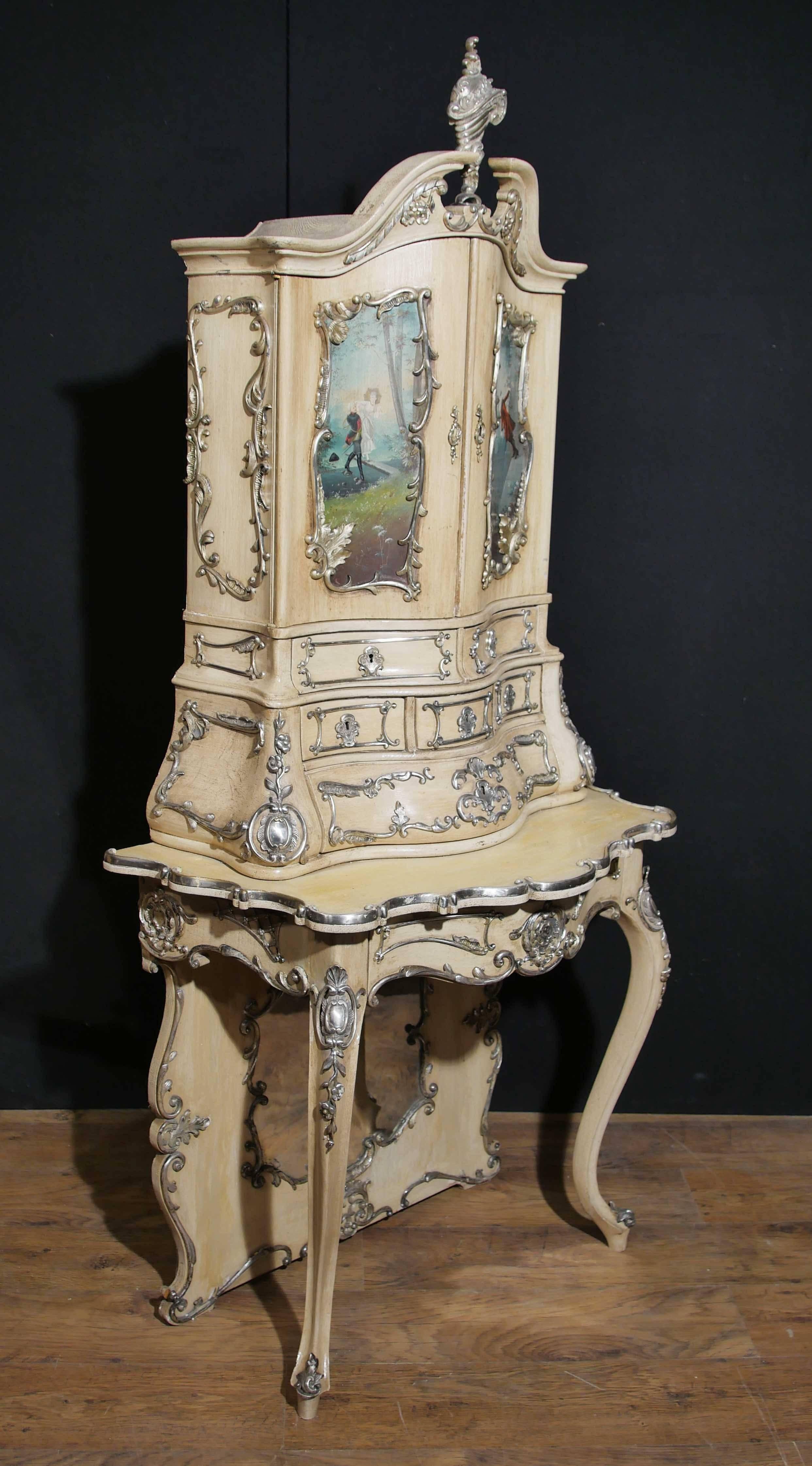 - Gorgeous antique Italian Florentine cabinet or bureau.
- Lovely painted finish in cream.
- This cabinet has the unusual feature of having silver plated bronze mounts.
- Painted panels show various scenes of Florentine courtly love.
- Really