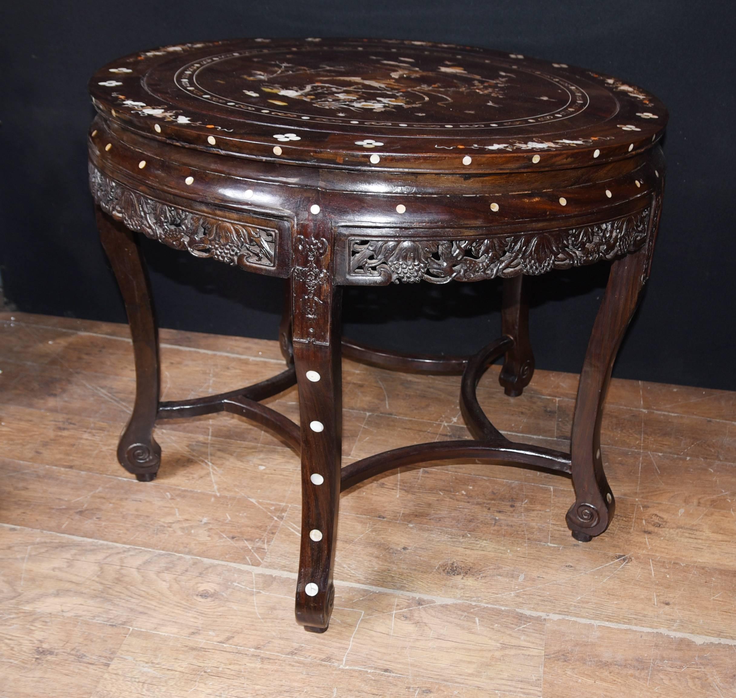 Gorgeous antique Chinese dining set with intricate mother-of-pearl inlay
Round table complemented by six stools
We date this wonderful dining set to circa 1920 and hence it's highly collectable
Classic inlay work showings Chinese motifs and