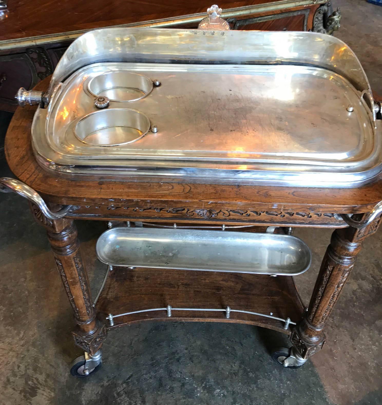 Stunning antique Maison Christofle silver plate beef trolley
Piece features two gravy boats
Intricately hand-carved wooden base in walnut, just look at the intricately carved details
It has two burners 
The dome is engraved 
This was purchased
