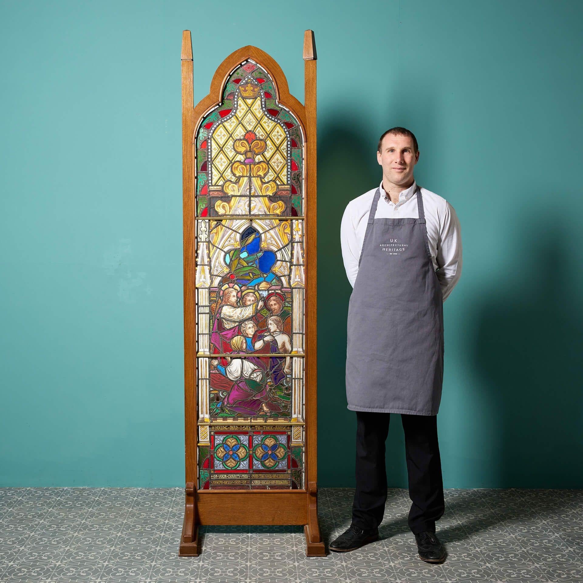 A large 19th century religious stained glass window in an unusual later oak frame.
 
Beautifully detailed and vibrant, this stained glass panel depicts a scene from the parable Jesus Heals a Centurions Servant. The glass itself is almost 2m tall,