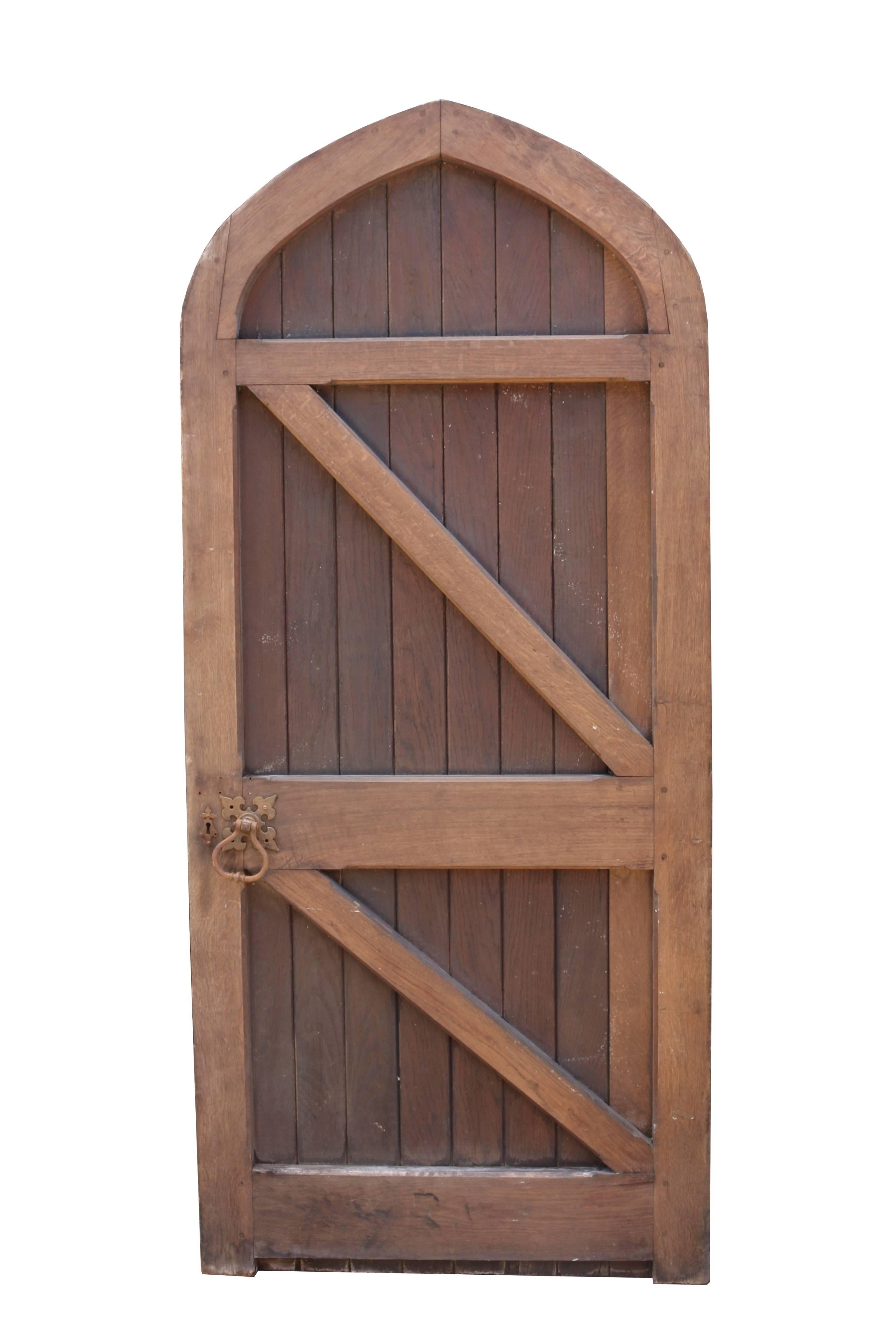 Late 19th century arched oak exterior door. Reclaimed from a church in Bath.