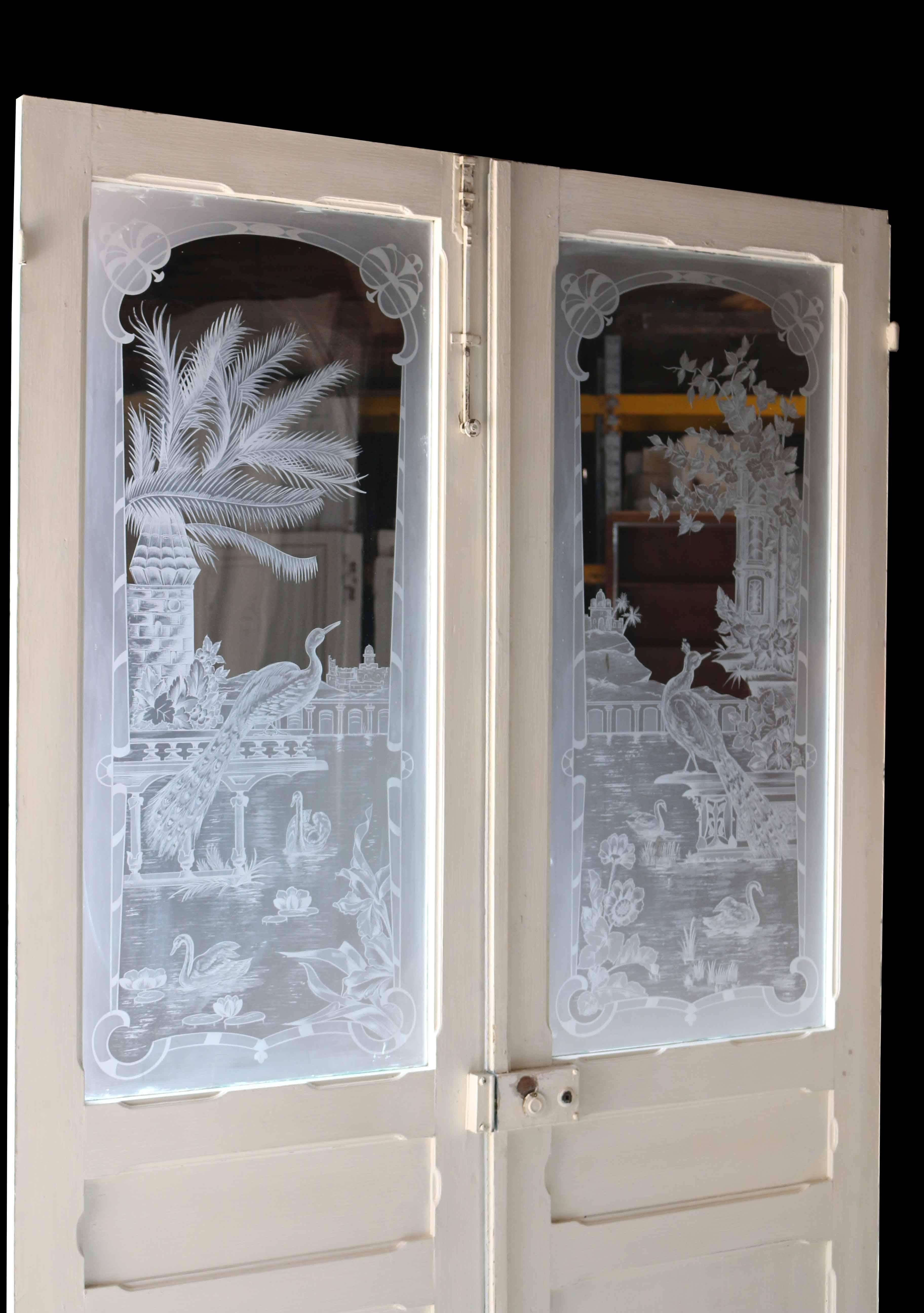 Pair of antique French etched glass doors. Doors constructed with oak frames.