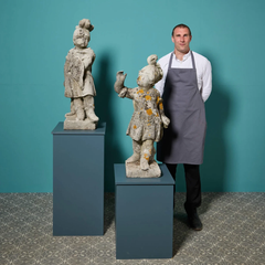 Pair of Weathered Stone Statues of Cherubs in Military Dress
