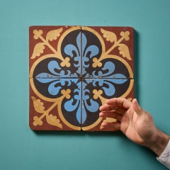 A Set Of Four Reclaimed Encaustic Floral Quatrefoil Tiles