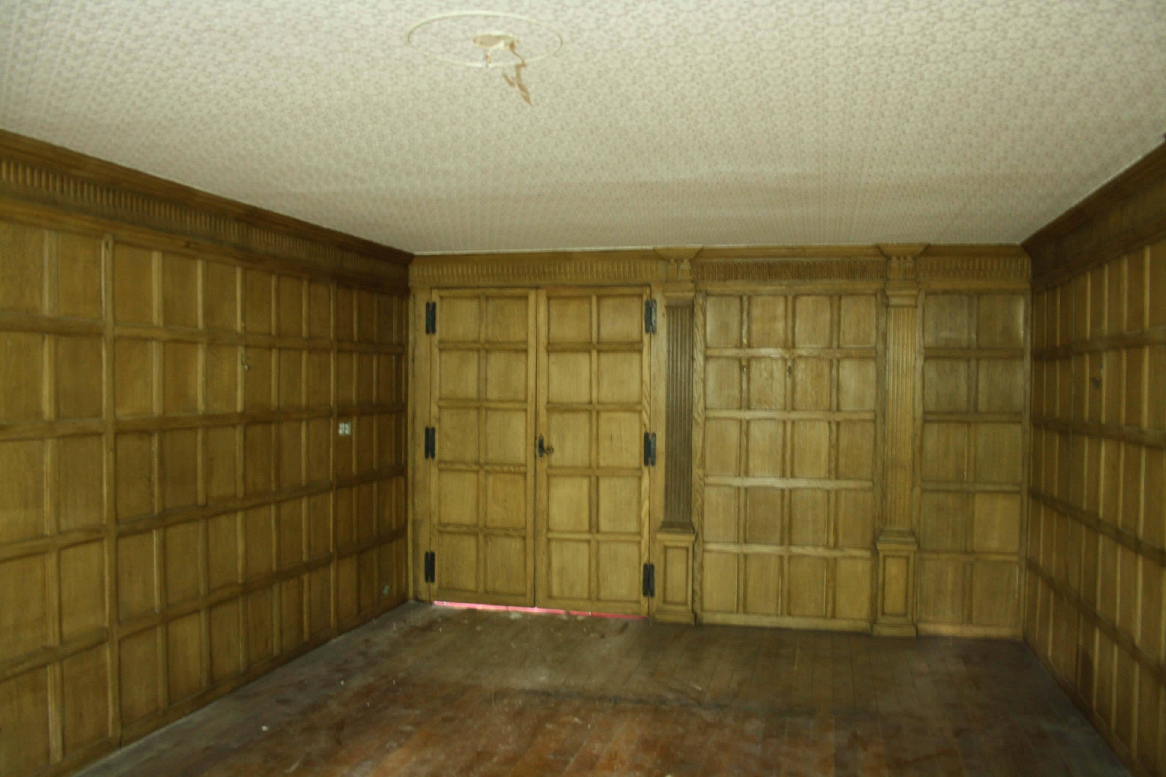 This paneling has been carefully removed from the dining room of a large house which is being demolished. The room has one pair of double doors, a single oak door and a further door of more recent manufacture, to the same design. There are