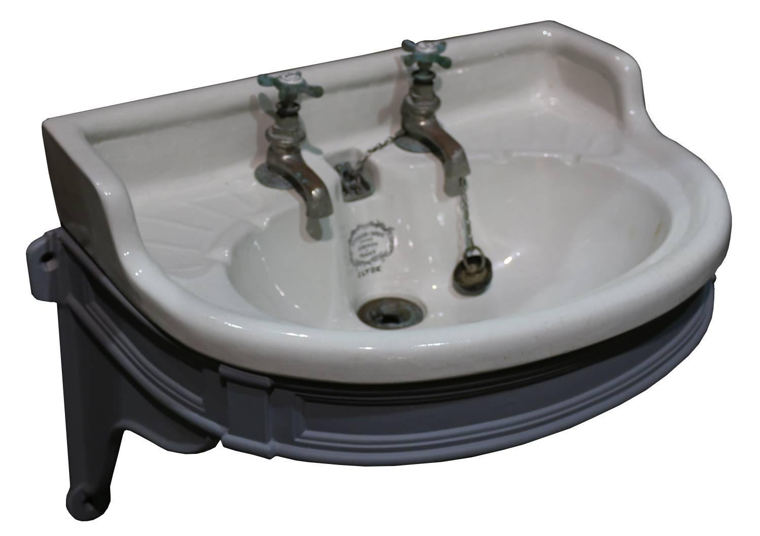 The taps are also by Tylor & Sons and are untested. The basin includes original plugs, chains and waste. The cast iron bracket is completely original and has been finished in a grey primer. The basin is in very good condition with no cracks and does
