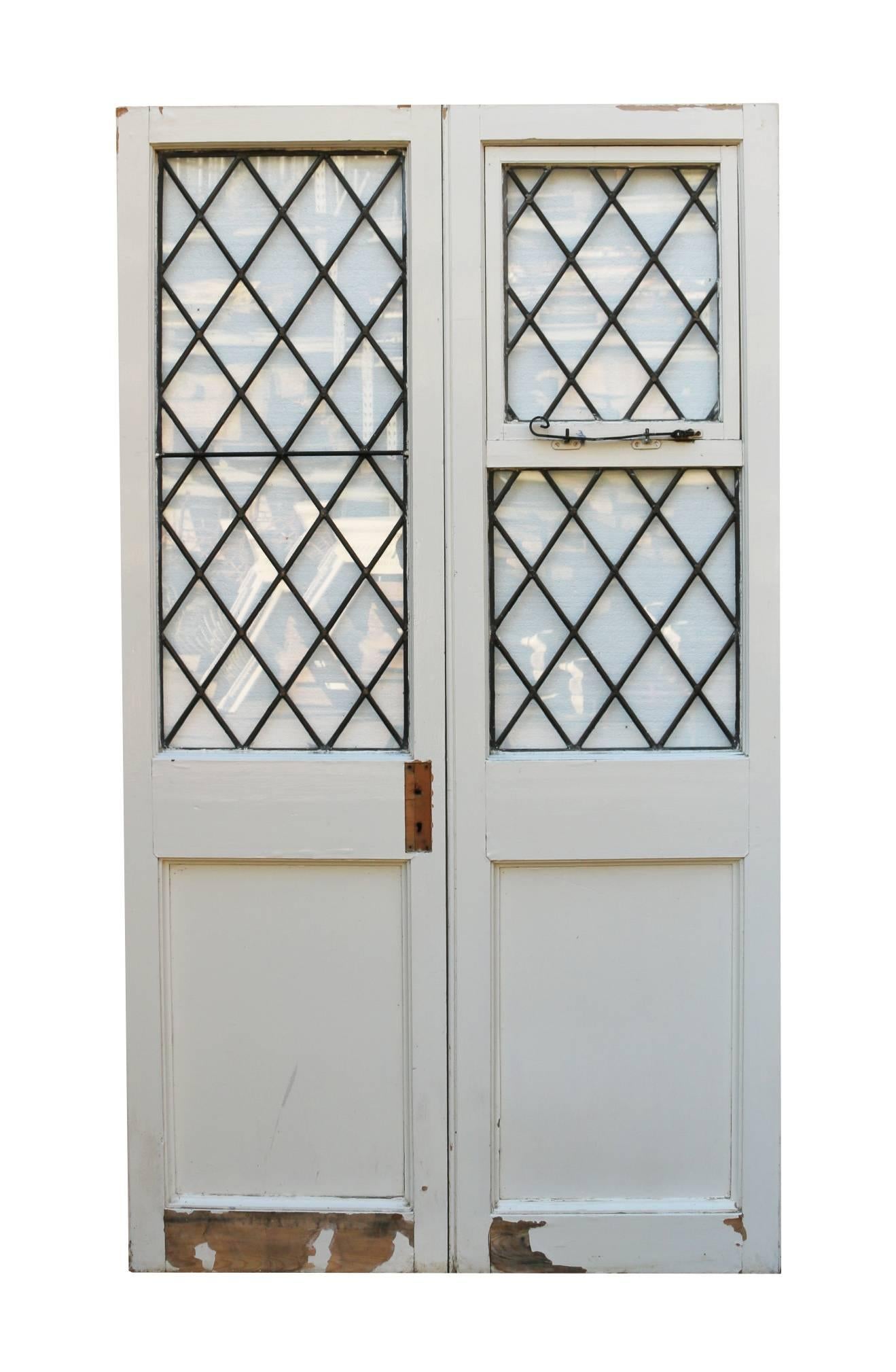 Pair of 1920s French pine exterior doors. (Please note that the glass is not insured in transit outside of the UK).