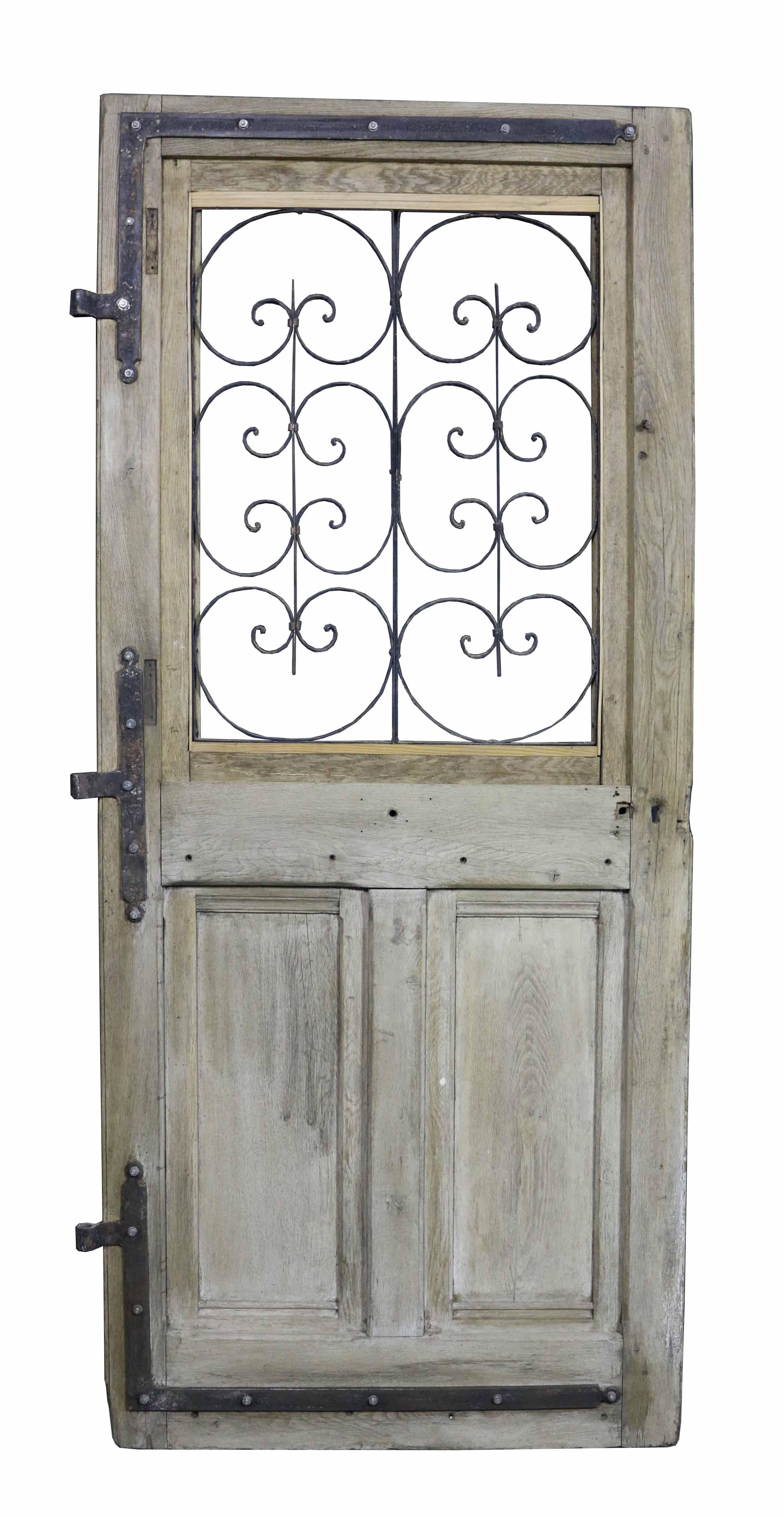 Antique French oak front door with iron grills. This door is not glazed.