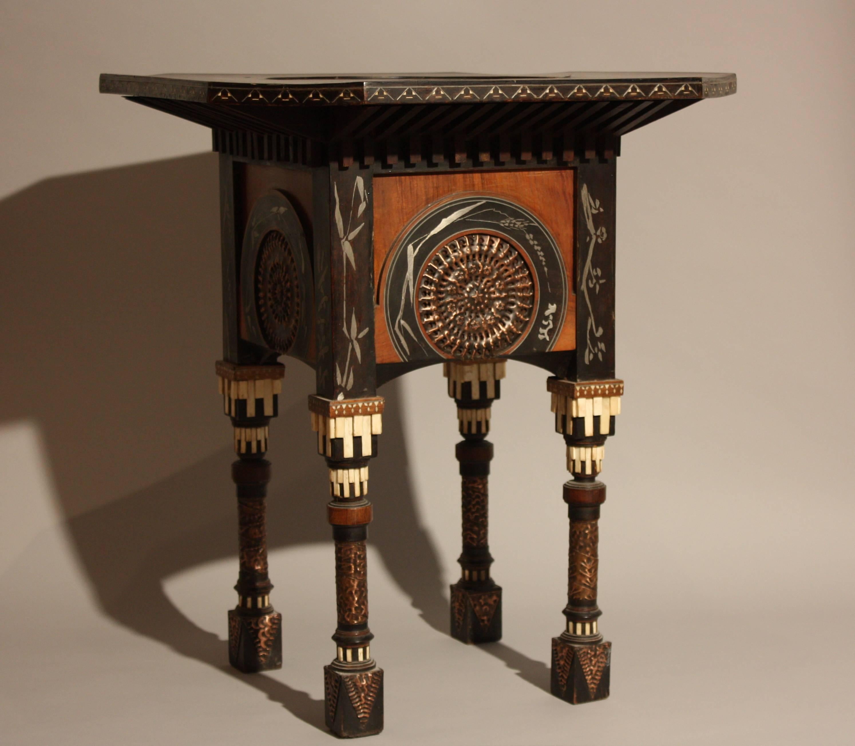 Carlo Bugatti occasional table in blackened wood, walnut, copper, pewter, bone and parchment. 
Octagonal blackened wood and parchment tray.
Circa 1900.
Width. 67 cm         Depth. 67 cm         Hight. 65 cm