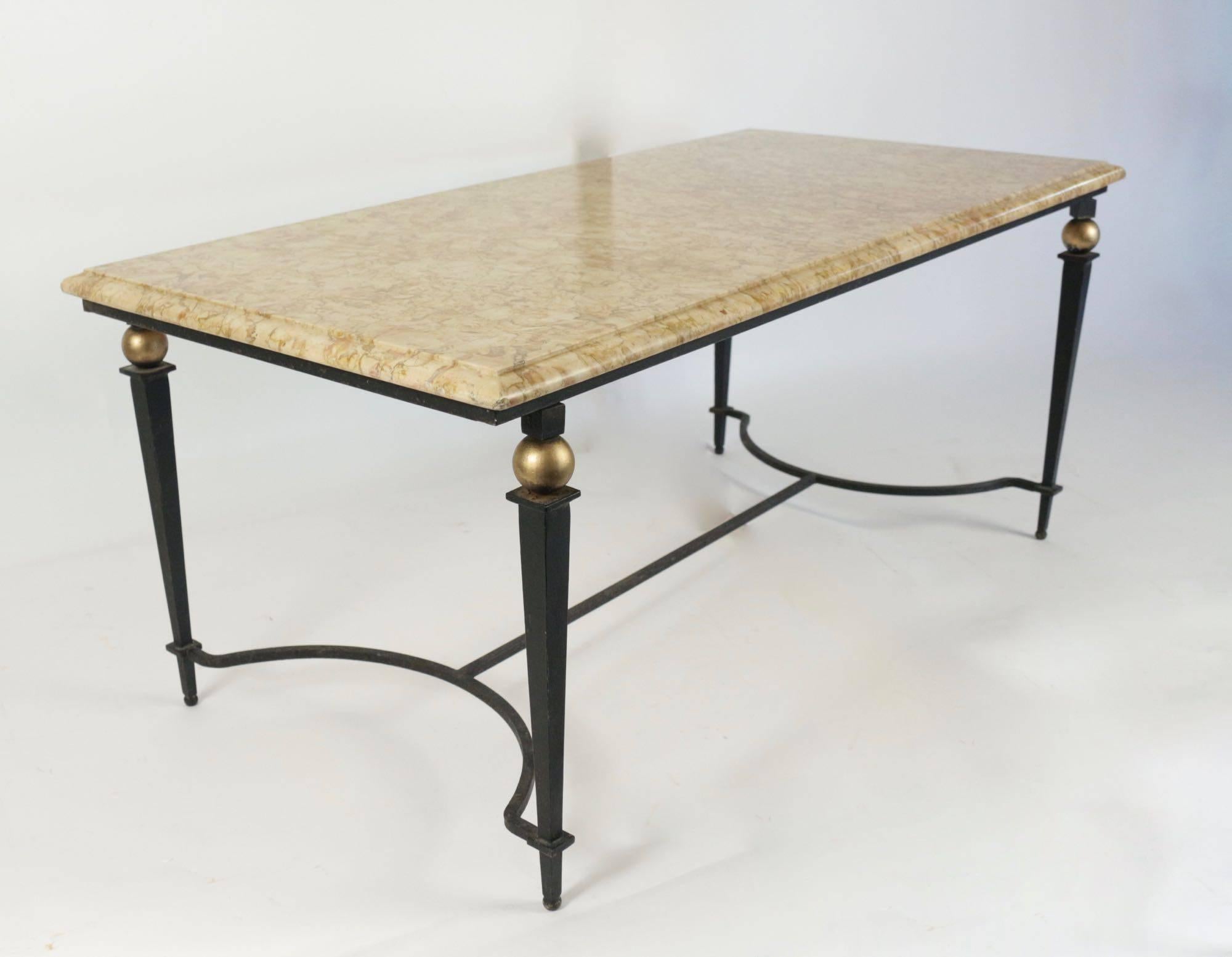 Wrought iron low table decorated with four golden balls with a marble top,
circa 1940.

Measures: Width 99.5 cm, depth 50.5 cm, height. 43 cm.
 