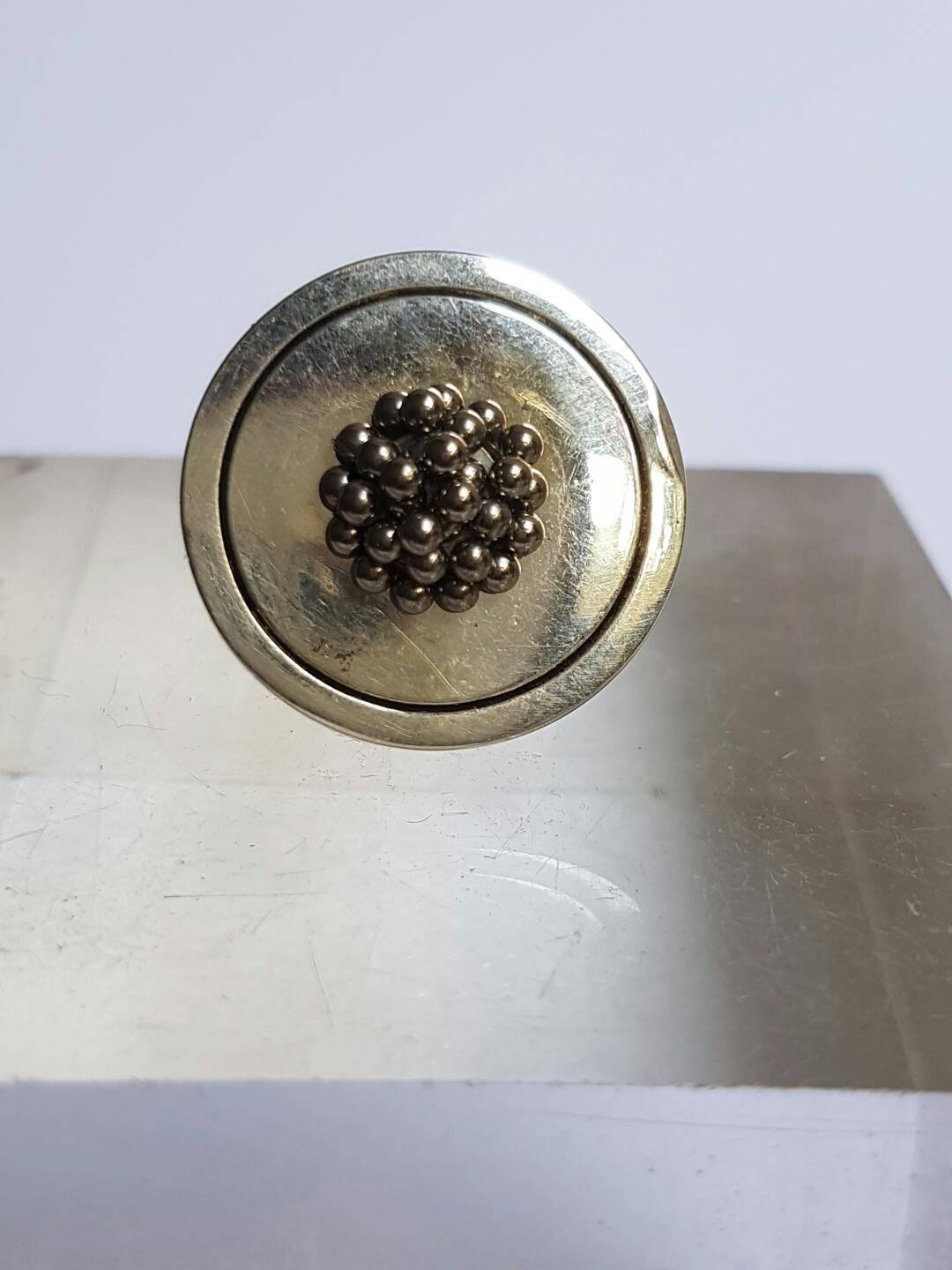 Silver plated ring with magnetic beeds. The ring is adjustable. Signed. Measures: Diameter 2.3 cm, height 0.8 cm