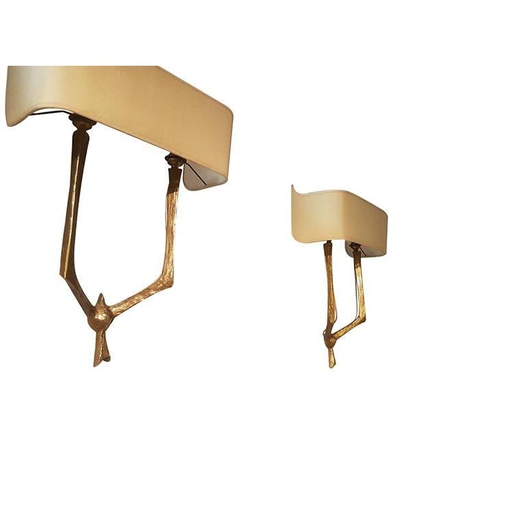 Pair of gilded bronze wall sconces by Felix Agostini.
Original shade.
Circa 1960.
Signed.
Dimensions without the shade:
Height. 35 cm            Width. 21.5 cm           Depth. 10 cm

Dimensions included the shade:
Height. 52 cm            Width. 38