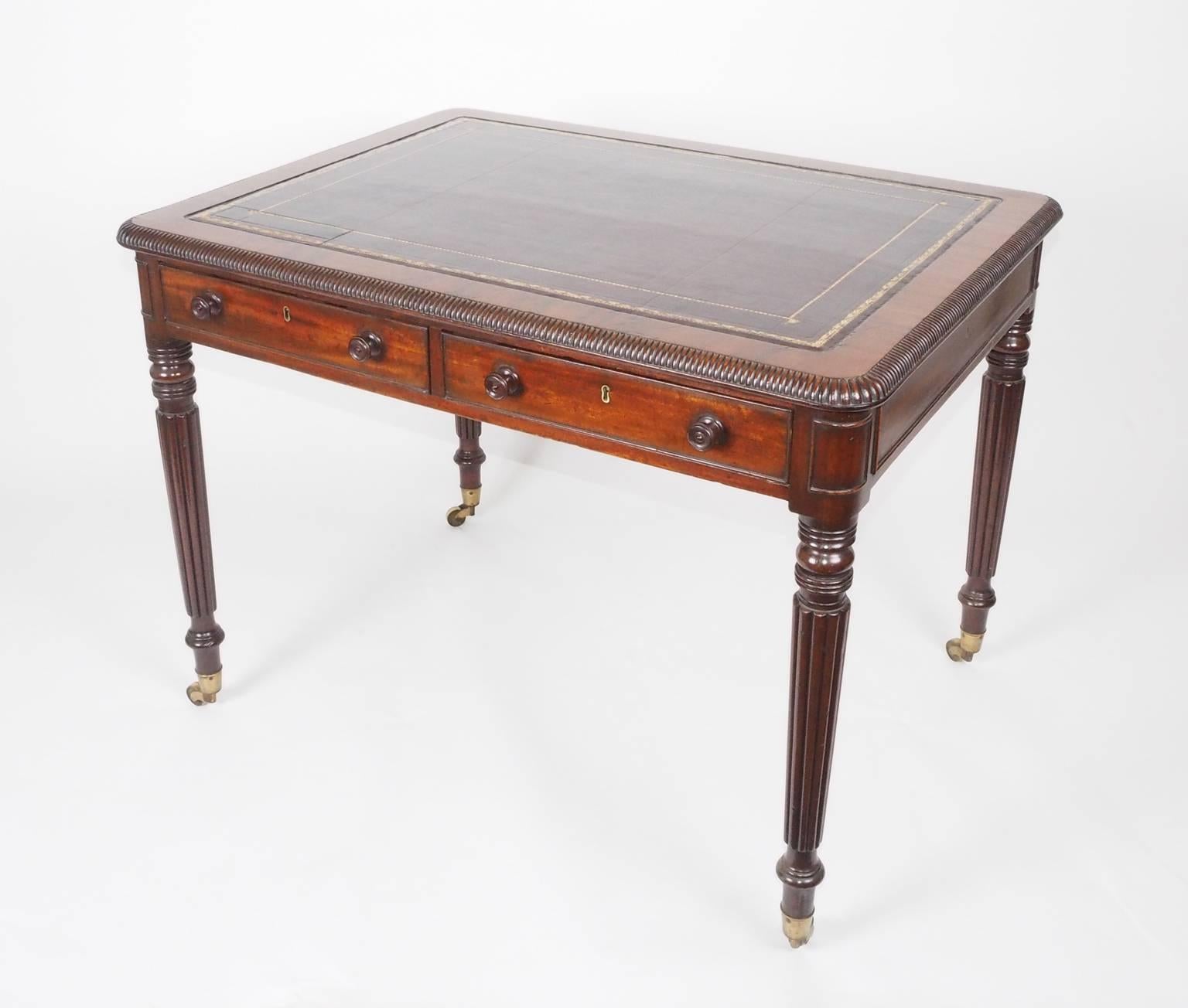 A George IV period leather lined mahogany writing table, the crossbanded mahogany
top with typical Gillows gadrooned moulding. The finely turned and reeded legs are another Gillow 
feature. Attributed to Gillows, bearing a later stamp for Edwards