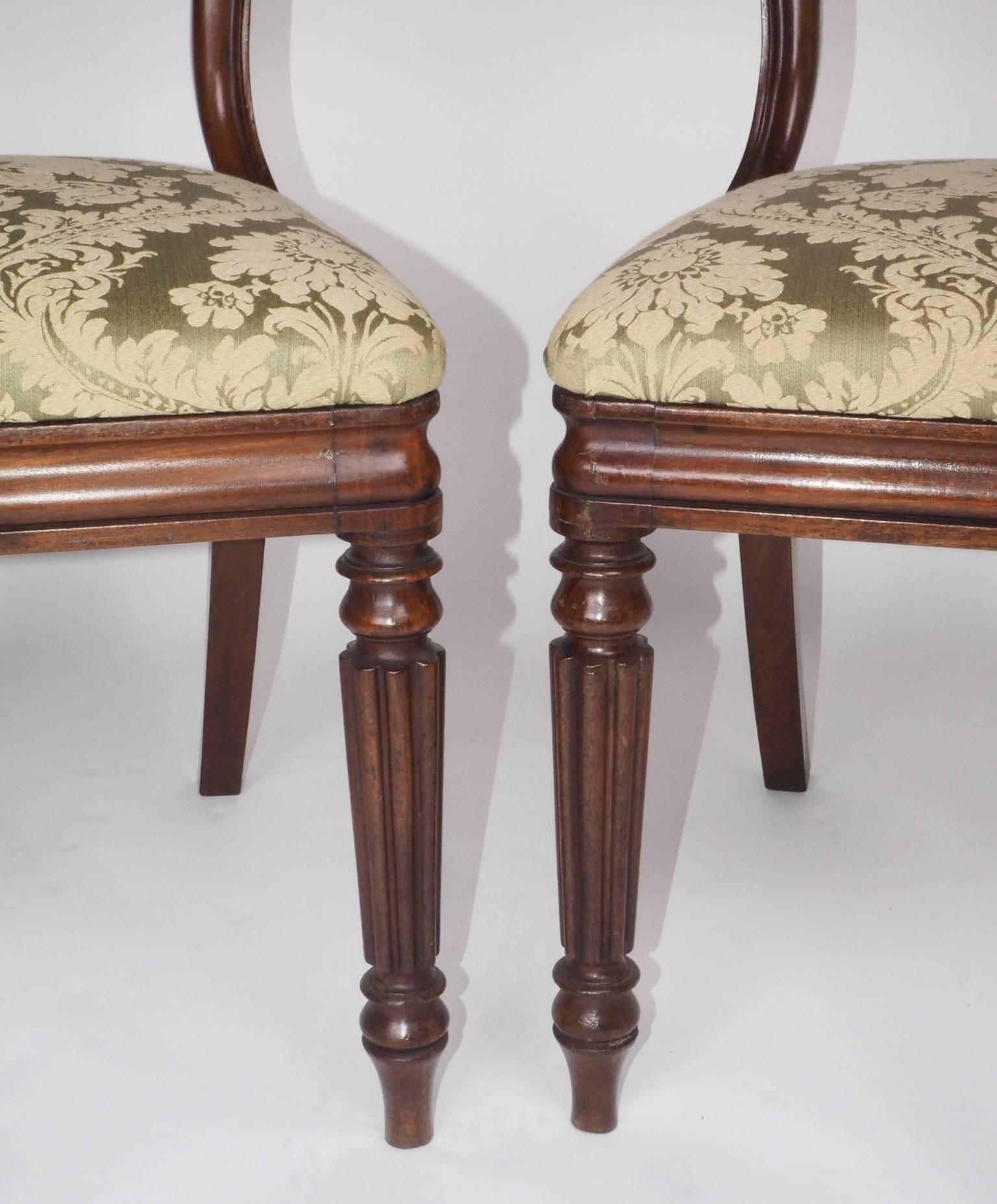 Pair of George IV period mahogany dining chairs with removable pads in the manner
of Gillows of Lancaster and London. The mahogany on the rails is applied to birch. See 
