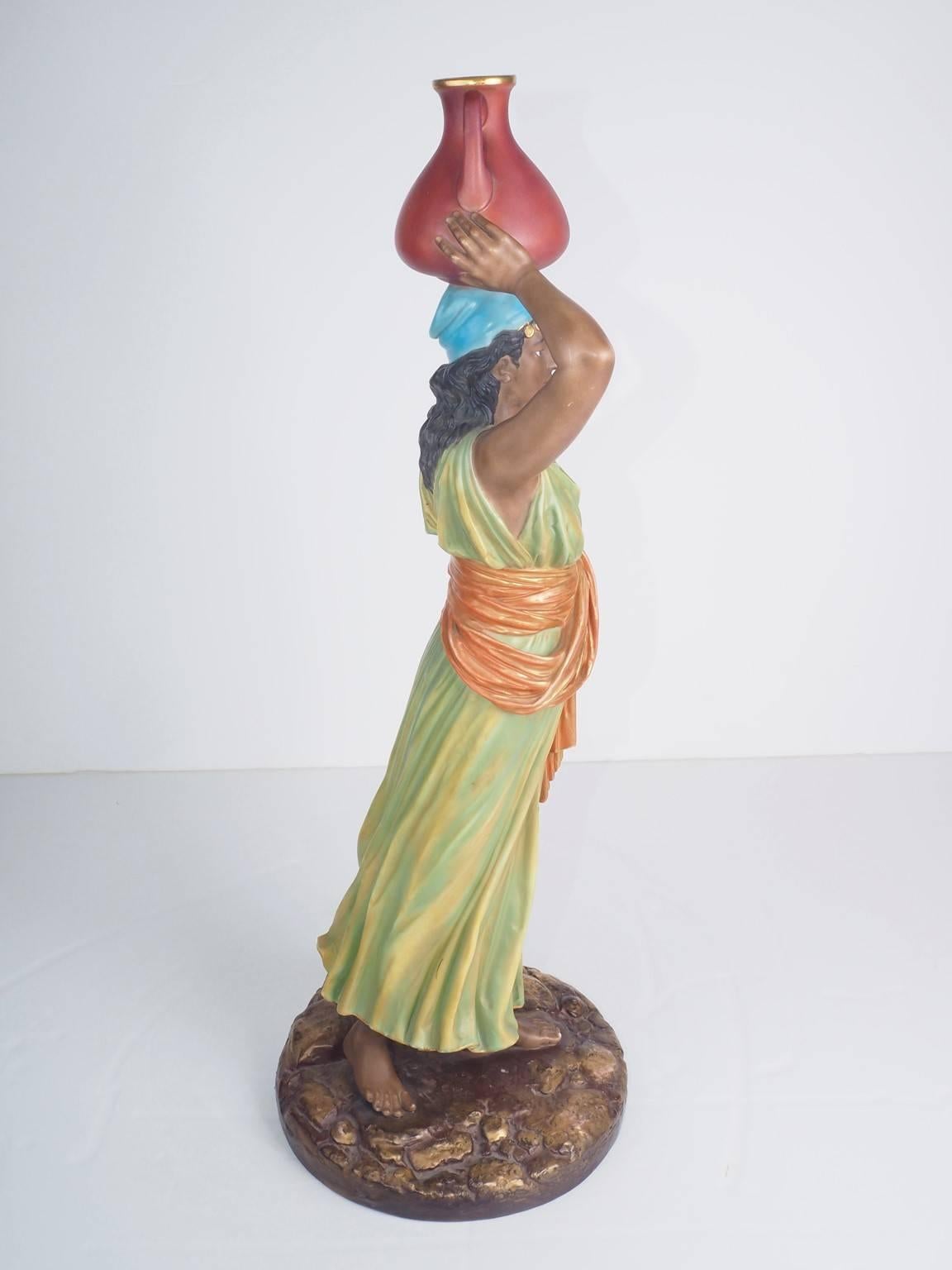 A 1898 Royal Worcester ceramic figure of a water carrier.