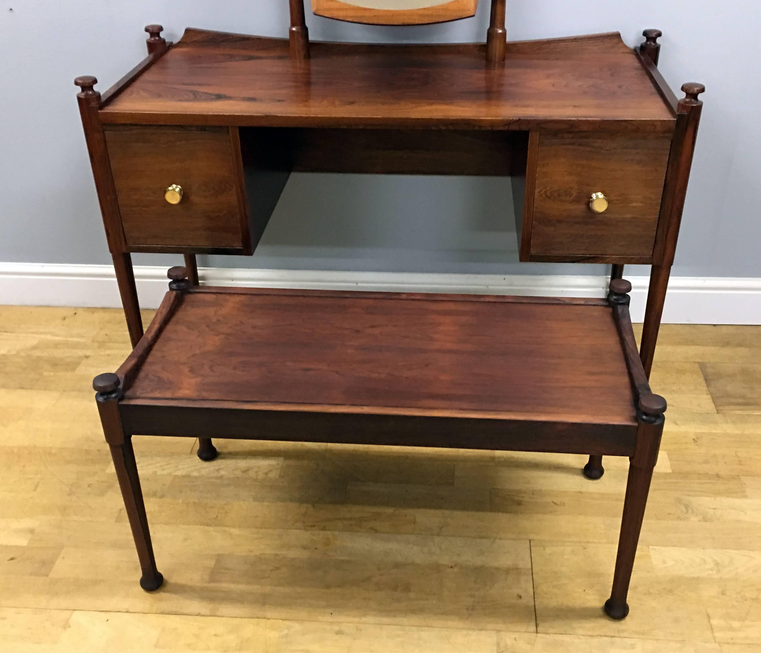 A very nice rosewood dressing or vanity table with matching long stool with loose sheepskin cover. The table with two drawers with brass handles and a swing mirror, and all in great condition.
Dimensions are 
table overall
height 120cm (with