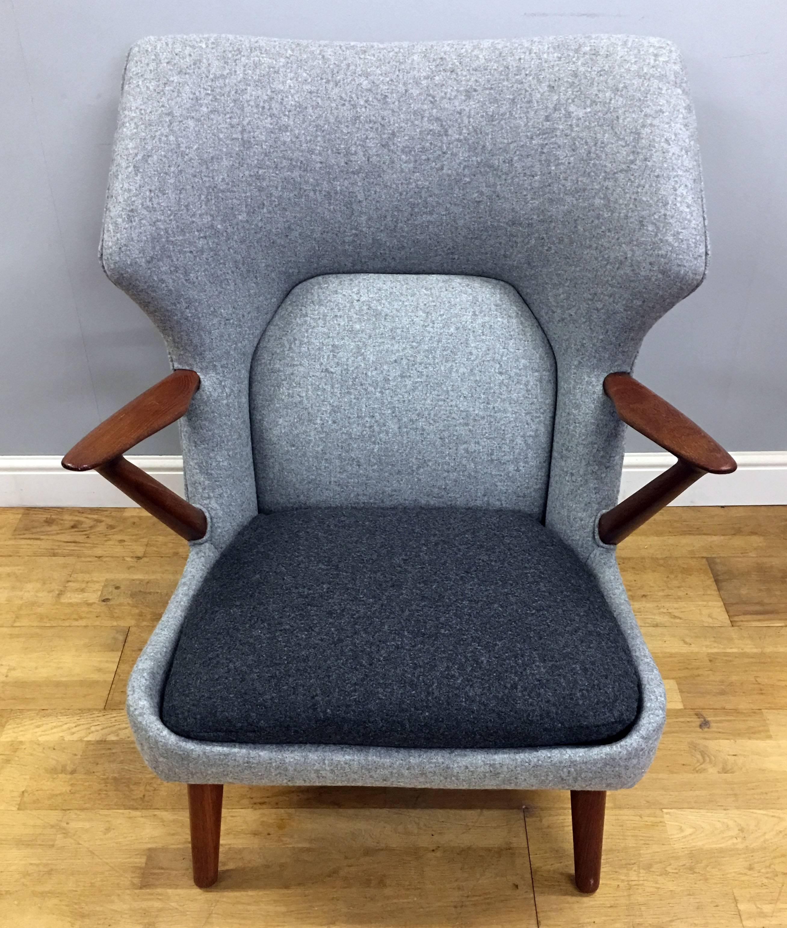 A beautiful early example, freshly reupholstered in finest quality wool fabric, as closely as possible to the original colour scheme of two shades of grey.