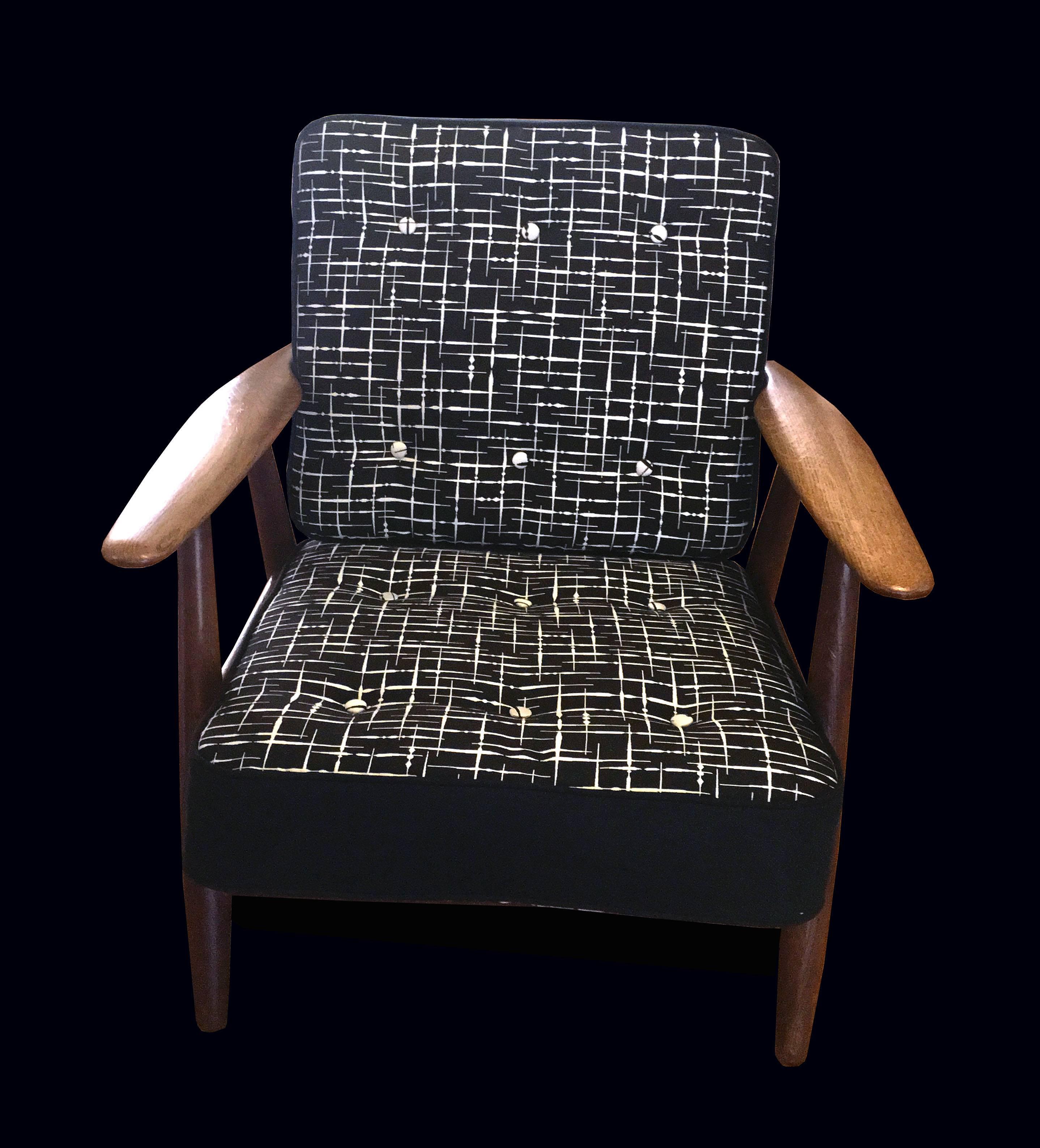 A very nice early original example with nicely patinated oak frame, retaining the original sprung cushions which have been freshly recovered in white on black on one side and black on white on the other side in an atomic pattern.