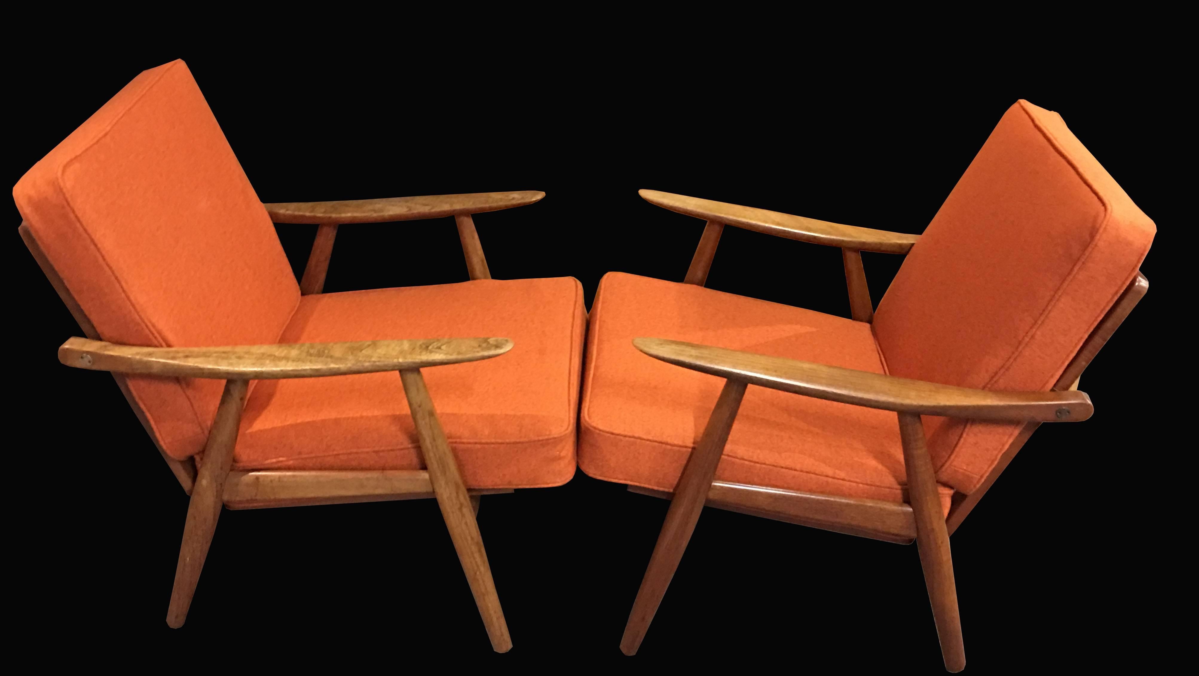 A very good original pair of these scarce model lounge chairs by Wegner, the frames in very good condition with a nice patina, new webbing and fresh new cushion covers in orange flecked wool fabric.