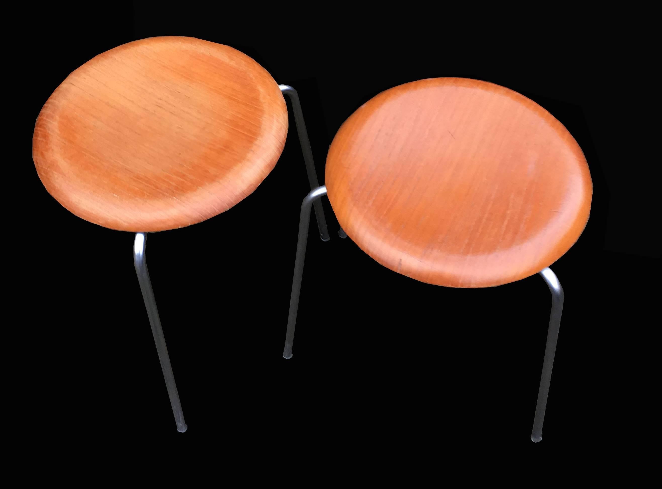 Very nice three-legged teak top pair of cool stools by Arne Jacobsen for Fritz Hansen.Just 2 left