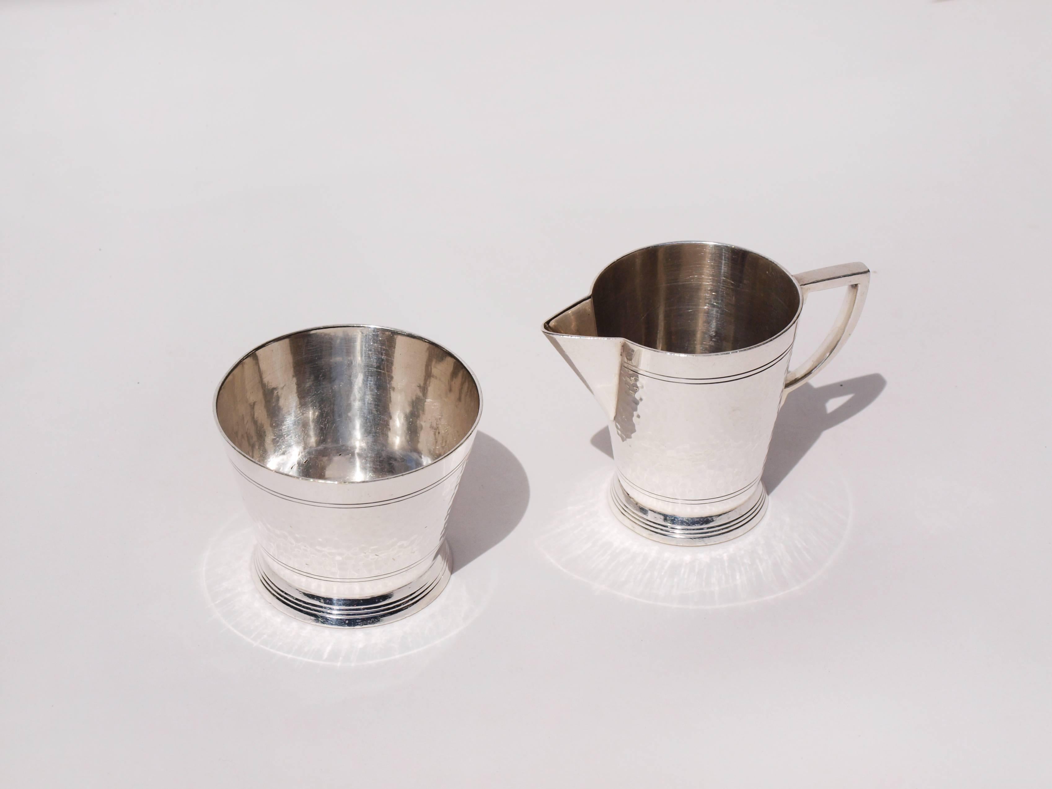 A rare Art Deco silver plated Mappin & Webb sugar bowler and milk jug designed by Keith Murray in the1930s with references and attributions in both the Vand A Museum and found in the Gemini book on Keith Murray.

The flared base has three incised