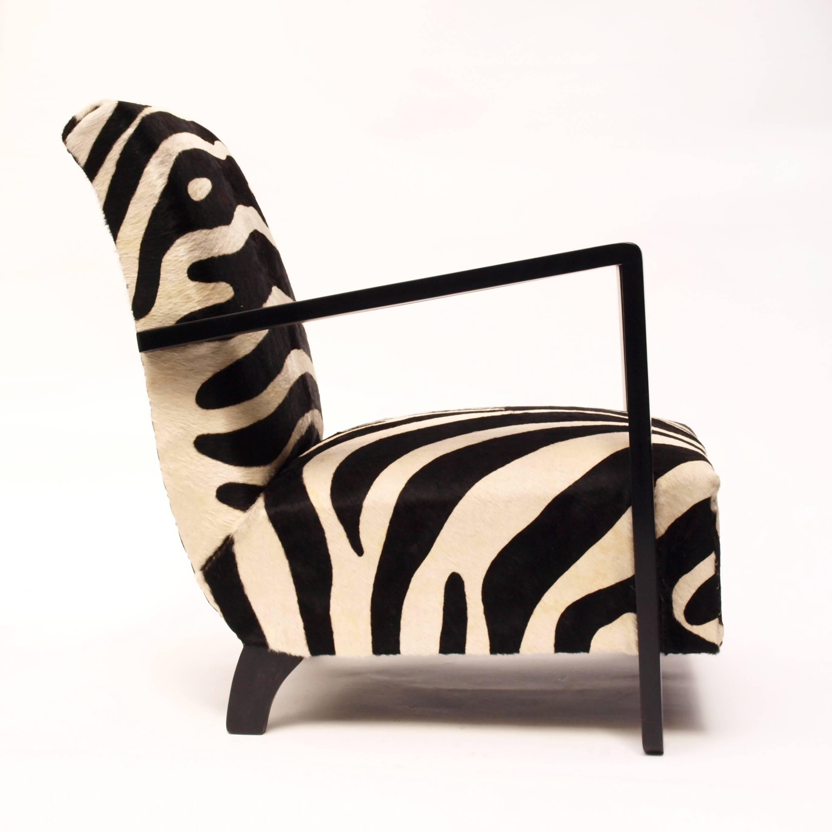 A  highly decorative French open arm chair in the manner of Rene Gabriel with beautiful proportions and upholstered with zebra print cowhide.