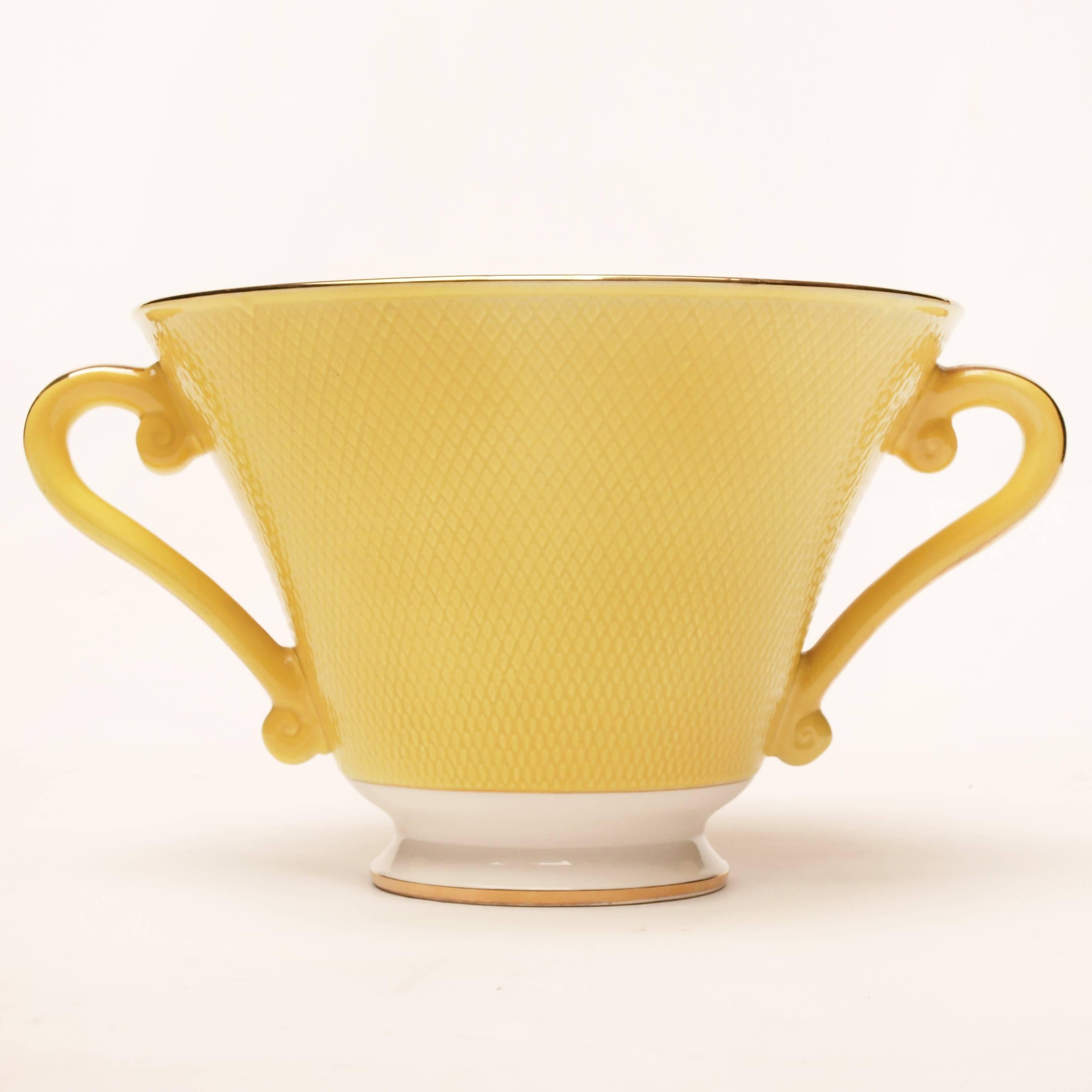 Glazed in lemon yellow and finished in gold trim This beautiful Salins centrepiece bowl has scrolled handles and traditional neoclassical proportions it’s slightly raised diamond pattern gives the appearance of turned enamel.
 
