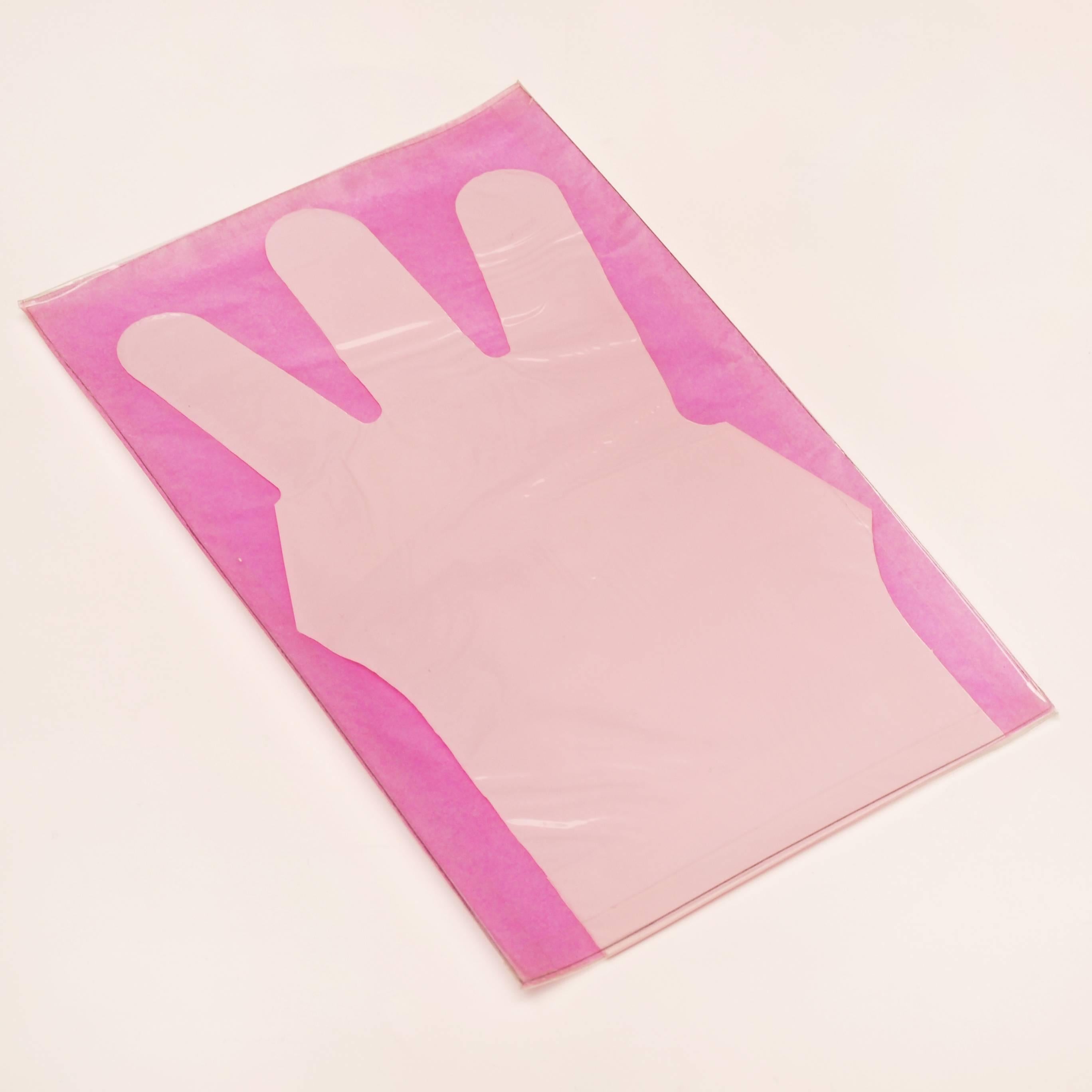 Enrico Baj, glove, 1968. An edition created by Italian artist Enrico Baj, of a glossy pink plastic glove holding three fingers up, held inside a mylar sleeve backed with fuchsia paper. From an edition of 2000 published by The letter edged in black