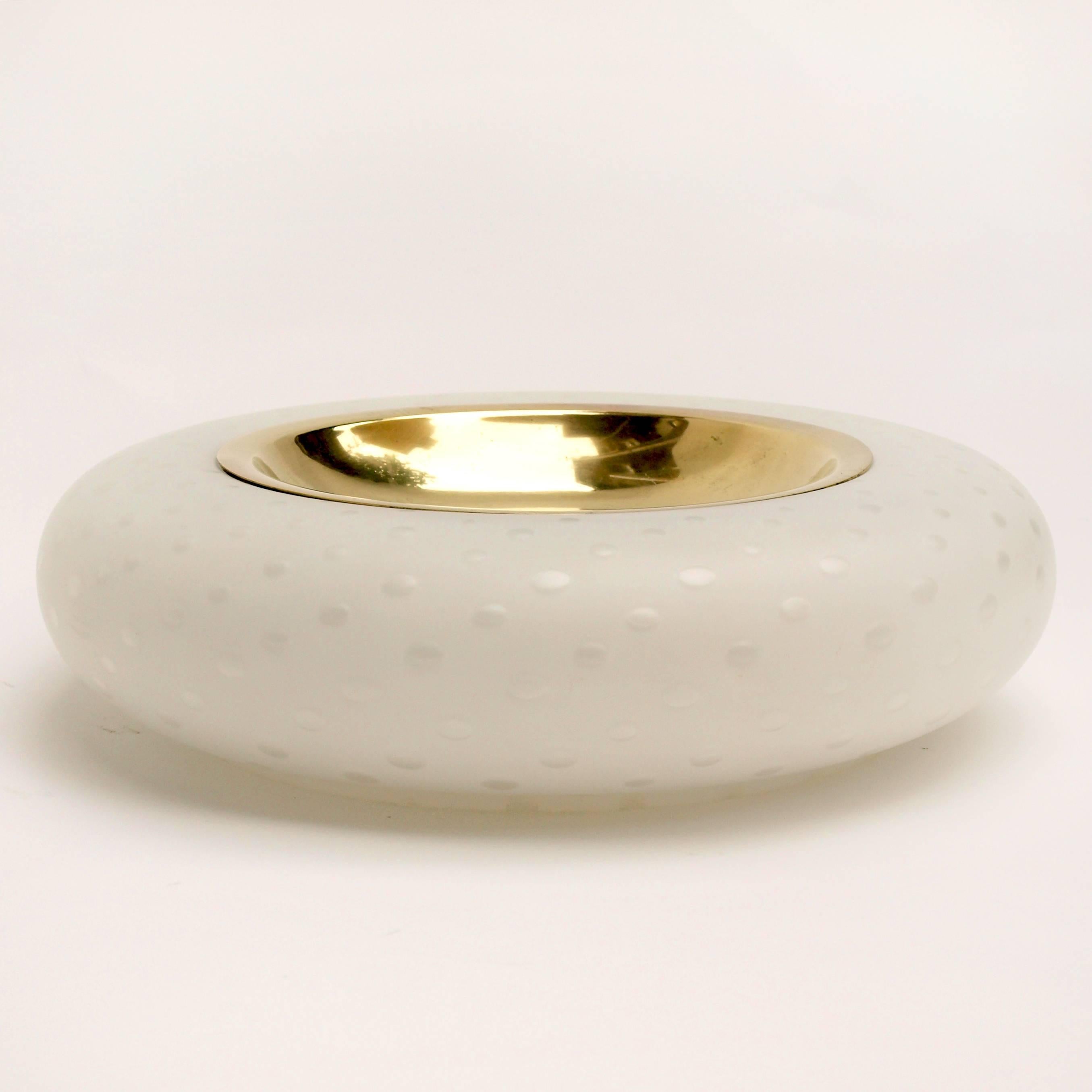 A large circular ashtray or bowl by Tommaso Barbi in brass and white polka-dot matte Murano glass.