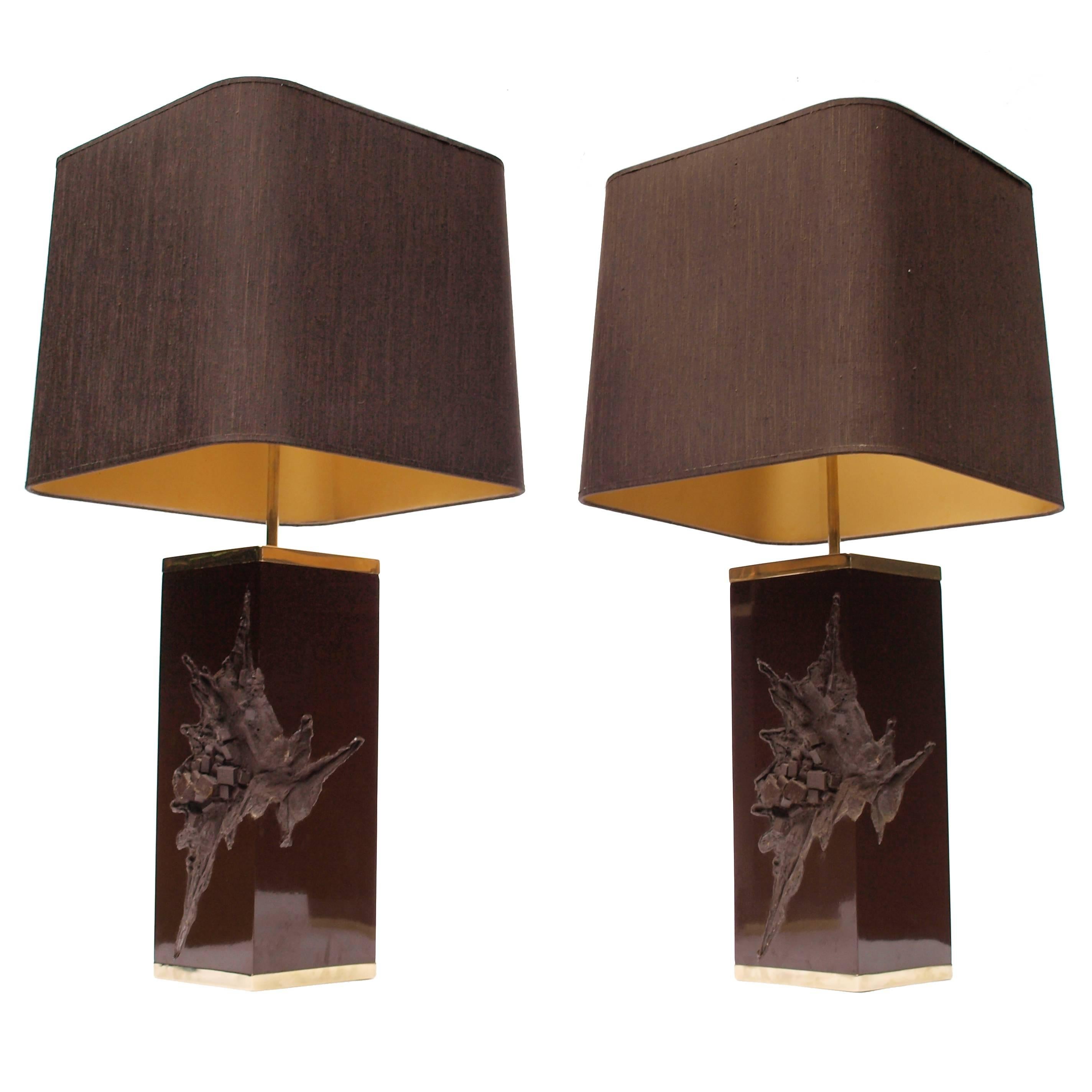 A grand pair of chocolate brown Philippe Cheverny lamps from the late 1970s cast in resin and cased on the top and bottom in gold metal edging. Finished with beautiful extending brass finials. With brown silk, gold lined lampshades.
  