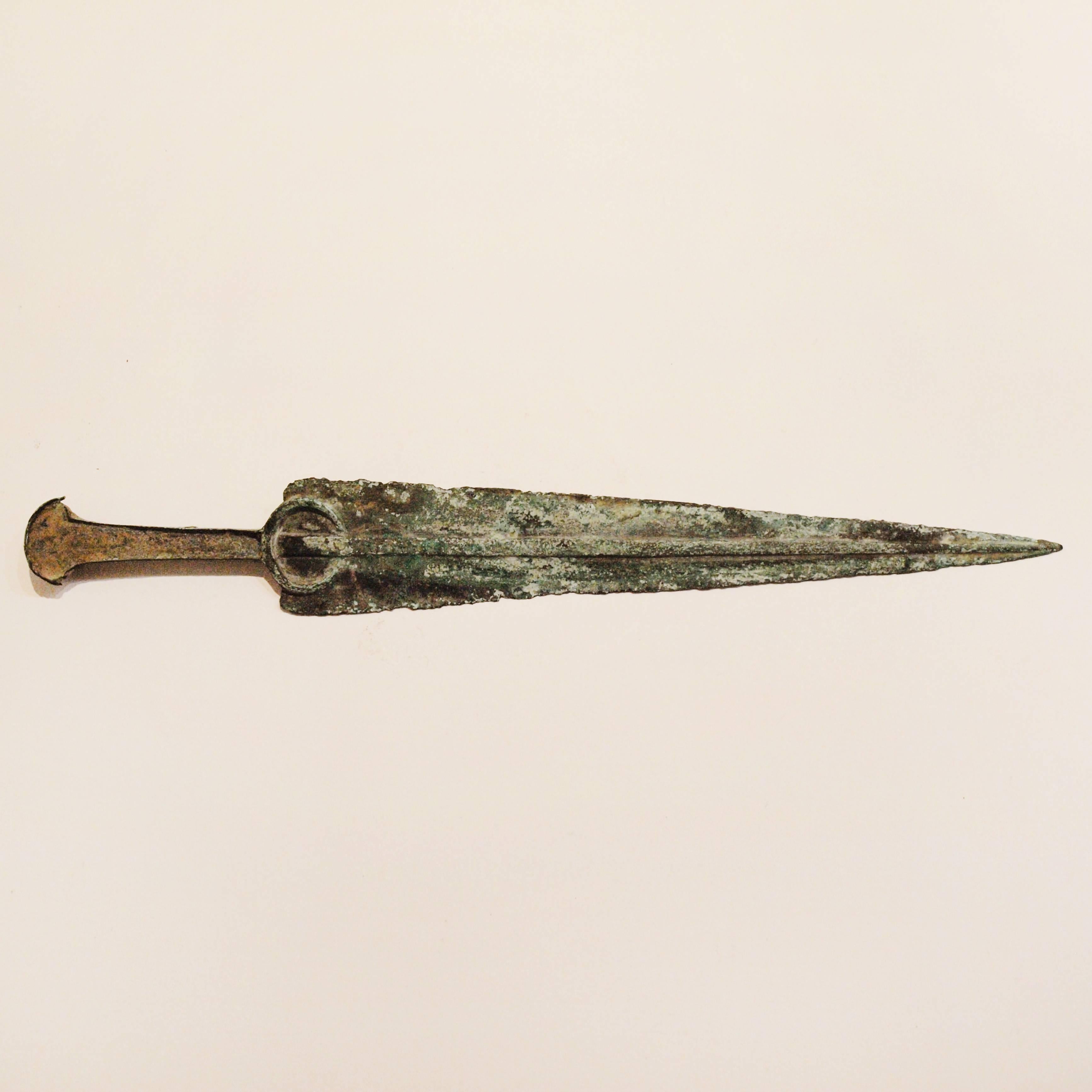 A very fine example of an authentic ancient Luristan bronze dagger, of elegant form, from the Iranian Marlik culture circa 1200 -1000 BC. A tapering double-edged blade with raised central rib and distinctive crescent shaped flanged hilt. 

This is a