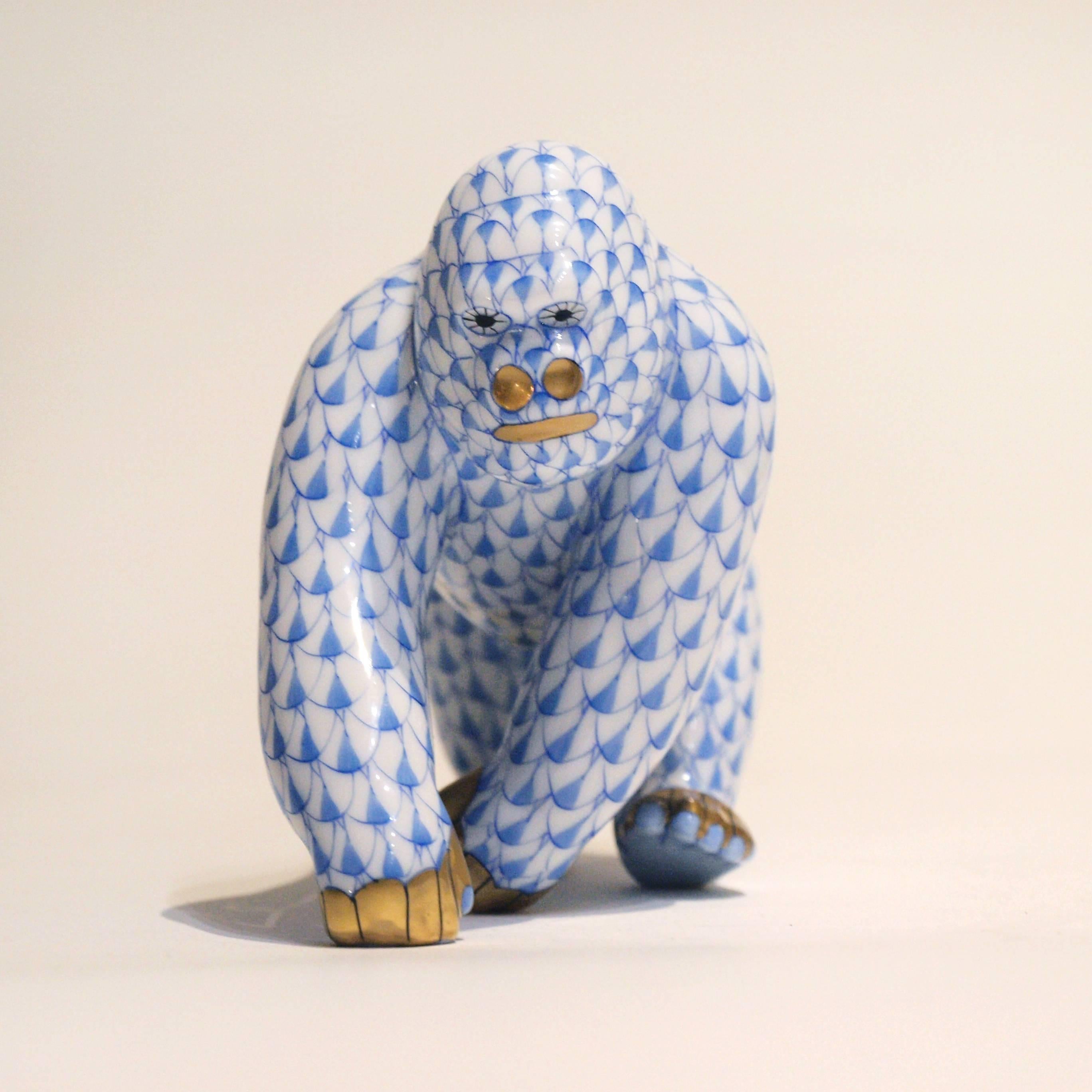 A Herend gorilla painted in Vieux Herend with blue fish scale. This fishnet or fish scale is a typical motif of Herend.