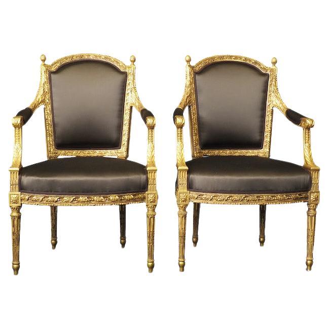 A magnificent set of four gilt Louis XVI chairs, comprising of two armchairs and two side chairs, circa 1780. 
Of exceptional quality these chairs are hand-carved and finished in gilt laid over gesso. Beautifully proportioned, the arms end with a