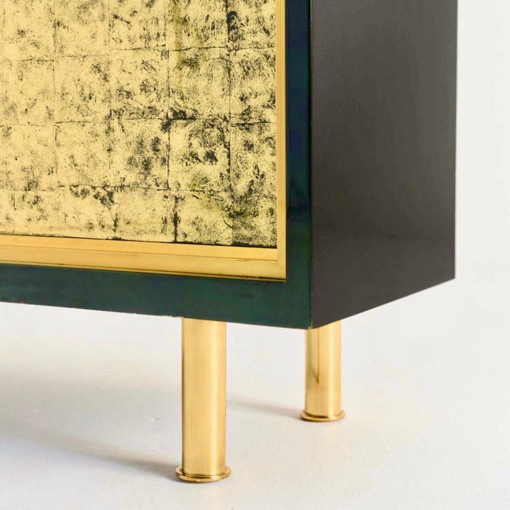 A very rare and unique dry bar by Maison Raphaël, circa 1950.
Finished in dark green Béka lacquer, with two sliding glass doors, a pull down front and two doors in gold clouded églomisé glass, the piece rests on cylindrical gilded bronze legs and