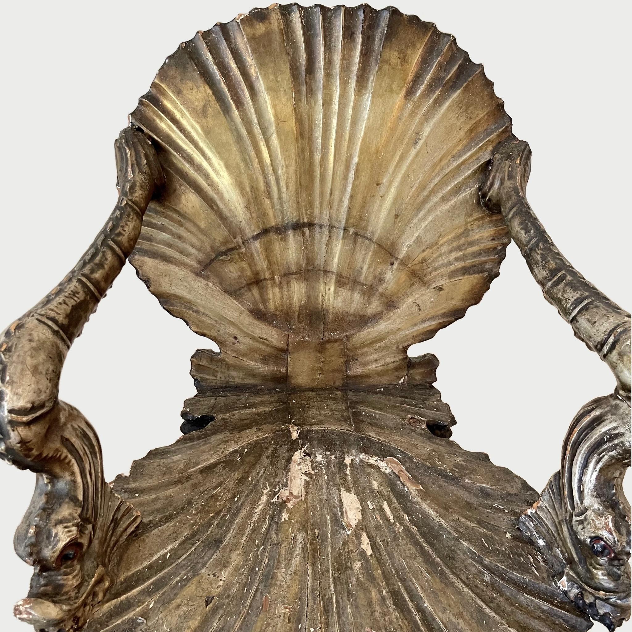 A pair of Italian carved, silvered and gilt 'Grotto' armchairs, attributed to Pauly et Cie Venetian, second half 19th century. Each in the form of an open scallop shell, the arms in the form of dolphins and legs in the form of conch shells.

Very