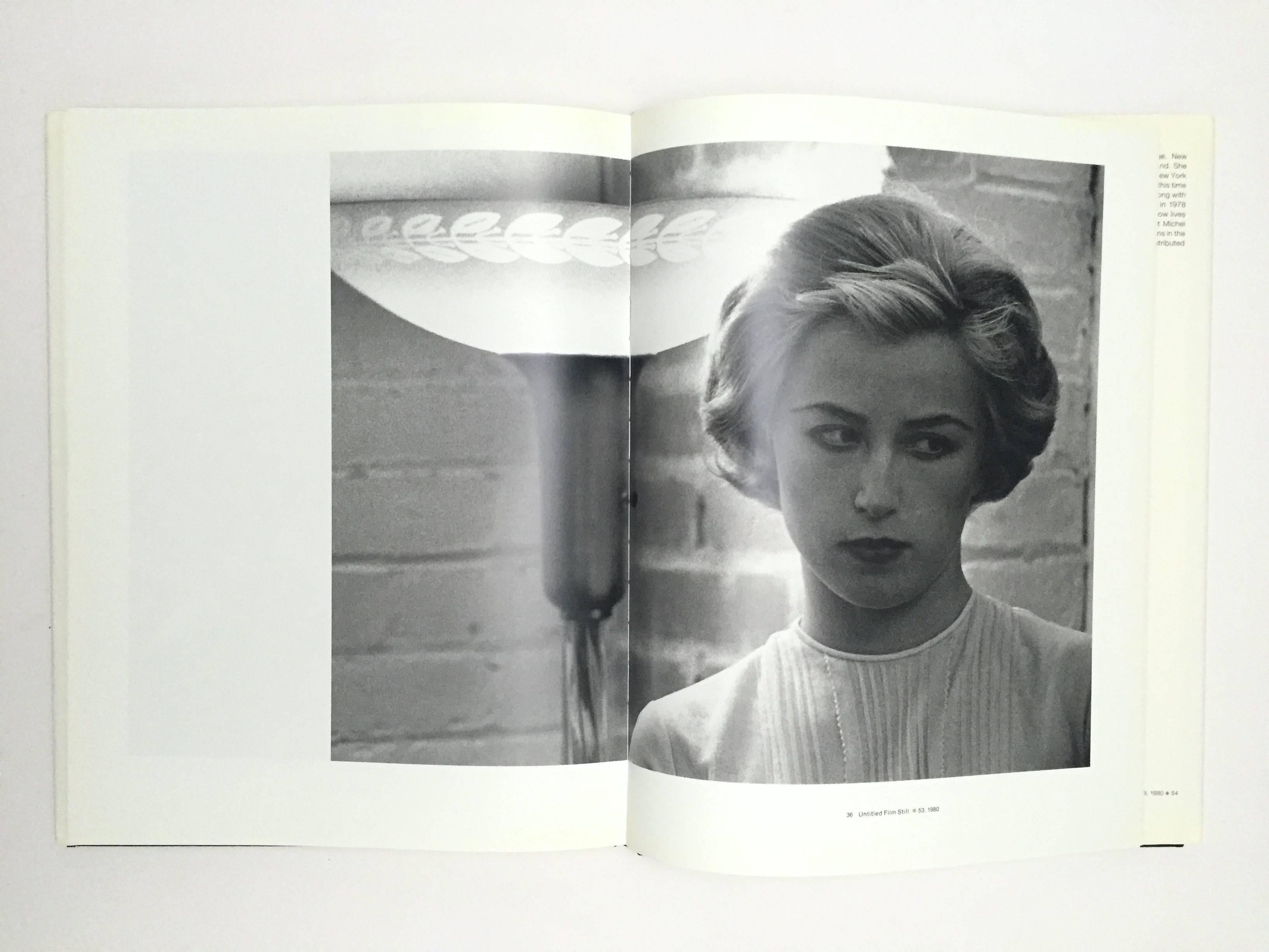 First edition, Jonathan Cape, 1990.

A monograph of Cindy Sherman's iconic early work, the 'Untitled Film Stills' series of 40 photographs, made between 1977-1980. These early staged images reference the editorials, films and imagery seen in the