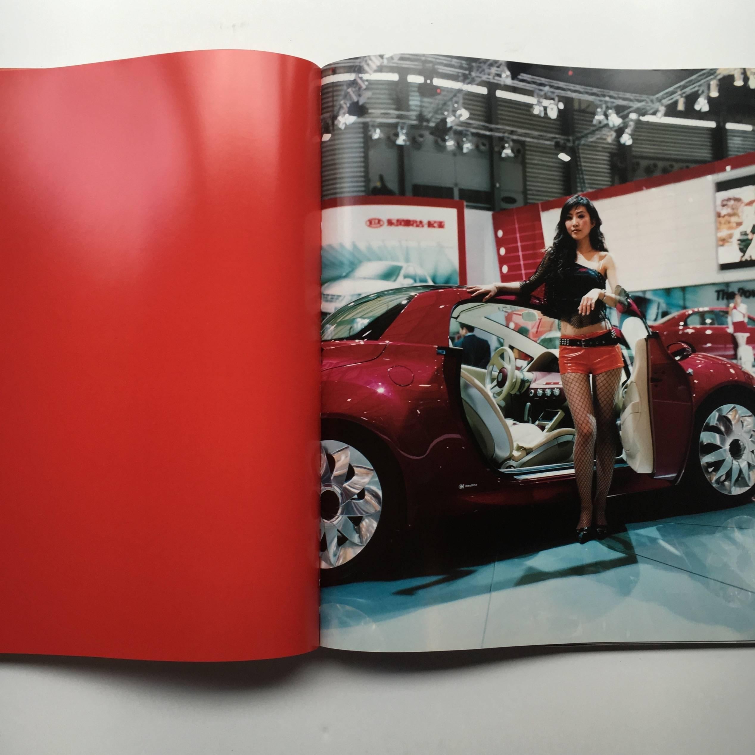 First edition, hardback in publisher’s original dust jacket, published by Aperture, 2009.

In this large, glossy publication, Jacqueline Hassink deconstructs the phenomena of the obligatory female model that stands beside a car at trade shows.