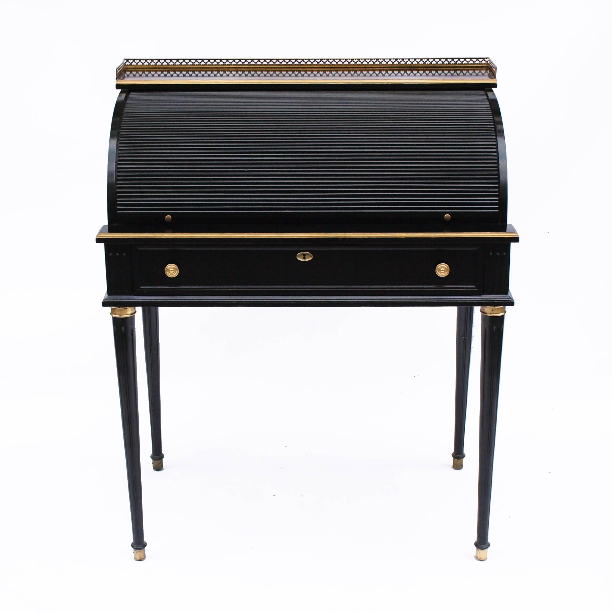 A beautiful Regency style black lacquer roll top desk, with gold gilt embellishments and brass detailing. The desk section slides outwards to create and extended writing area.