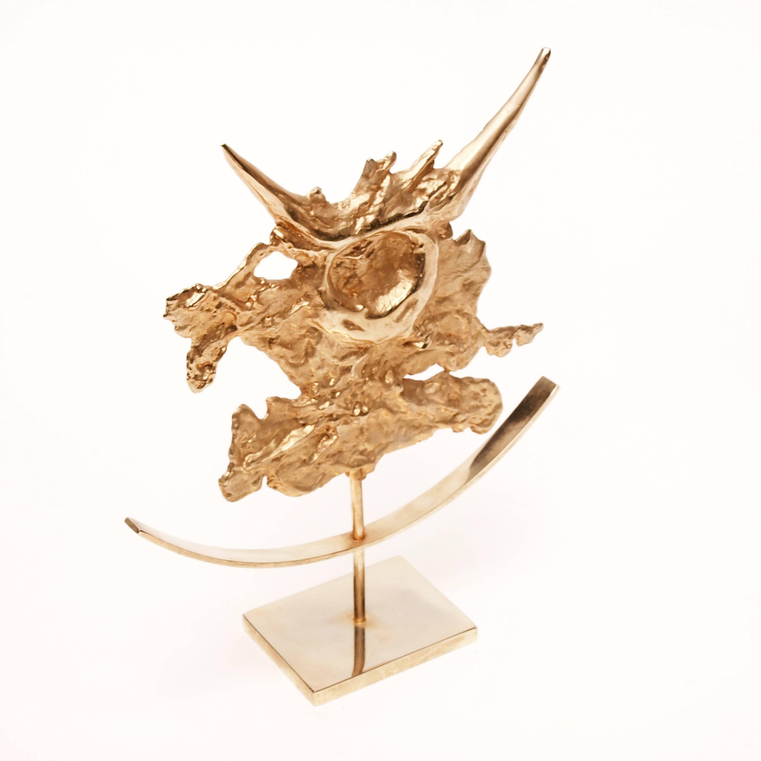 A gilded Taurus zodiac sculpture by Philippe Cheverny. The French designer is known for his ornamental pieces, sculptural lamps and furniture designed and manufactured throughout the 1950s-1970s. His works have since become sought after for their