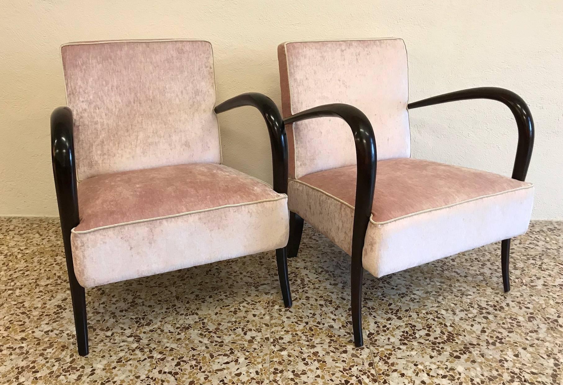 This is a Classic pair of original Italian Art Deco armchairs with mahogany tinted wood arms and new pink and ivory velvet upholstery.
 